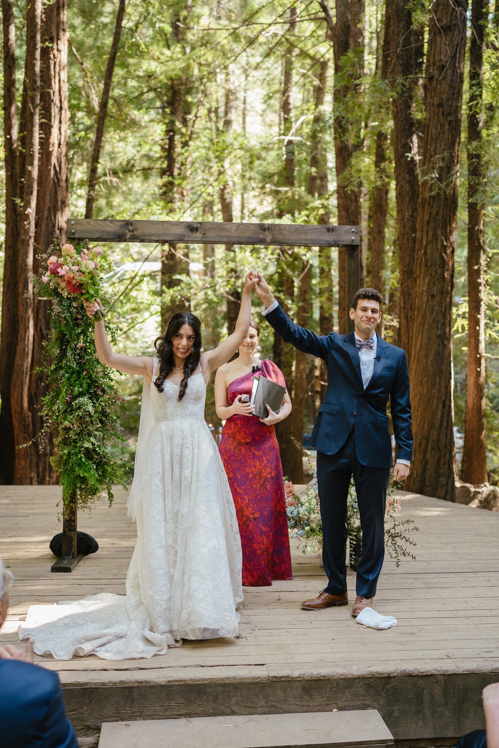 Adam and Lala raising their arms at the end of the ceremony