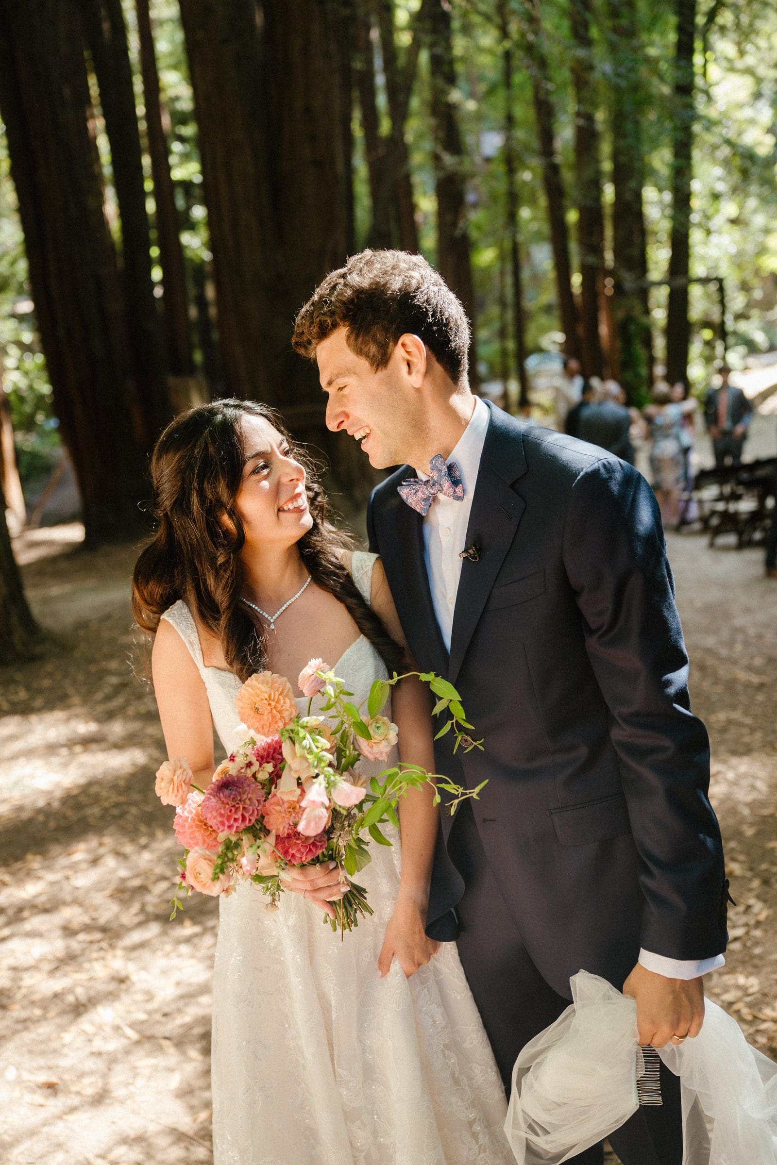 Adam and Lala walking through the redwoods after the ceremony