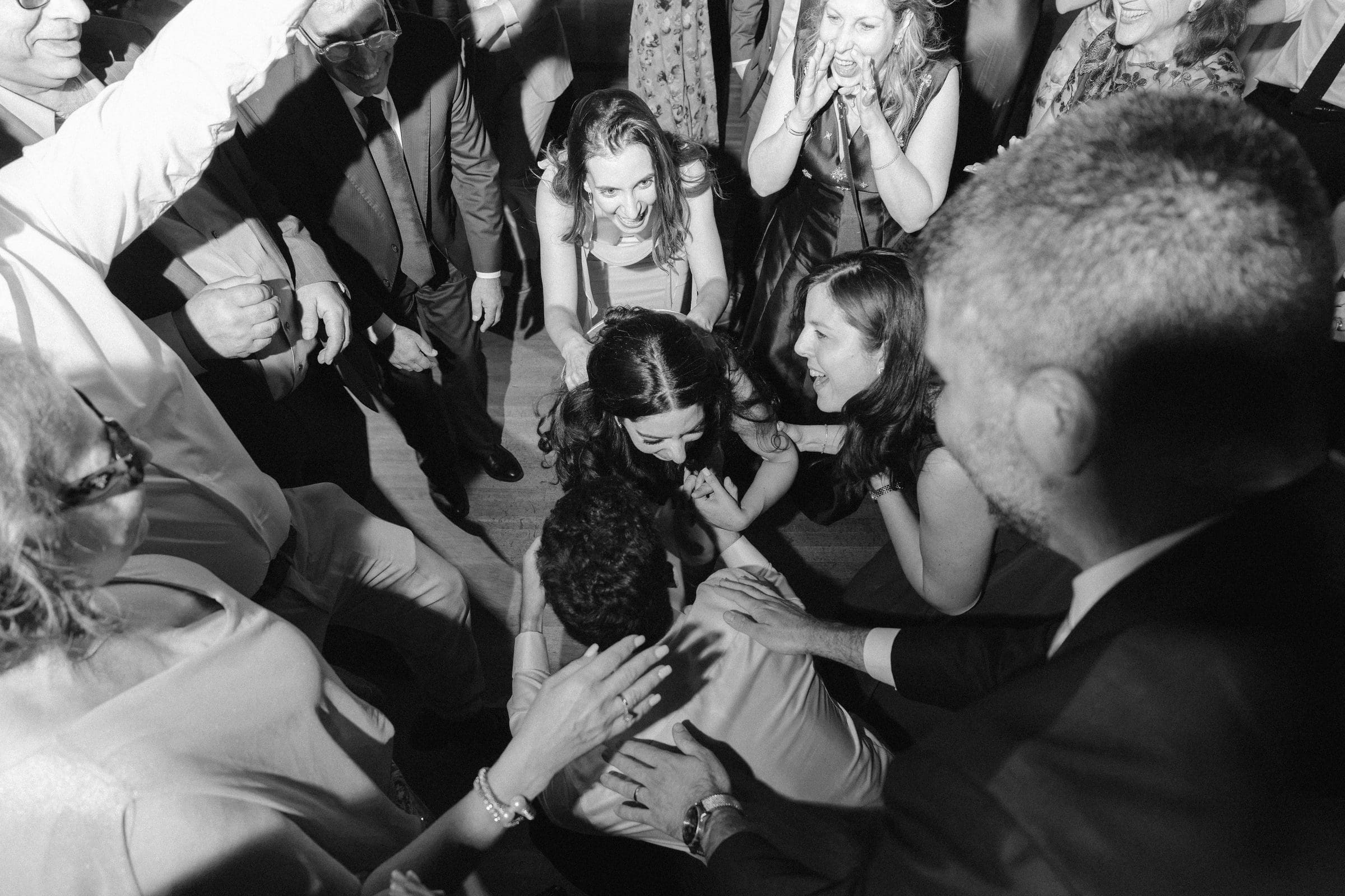 Guests crowding the dance floor, black and white