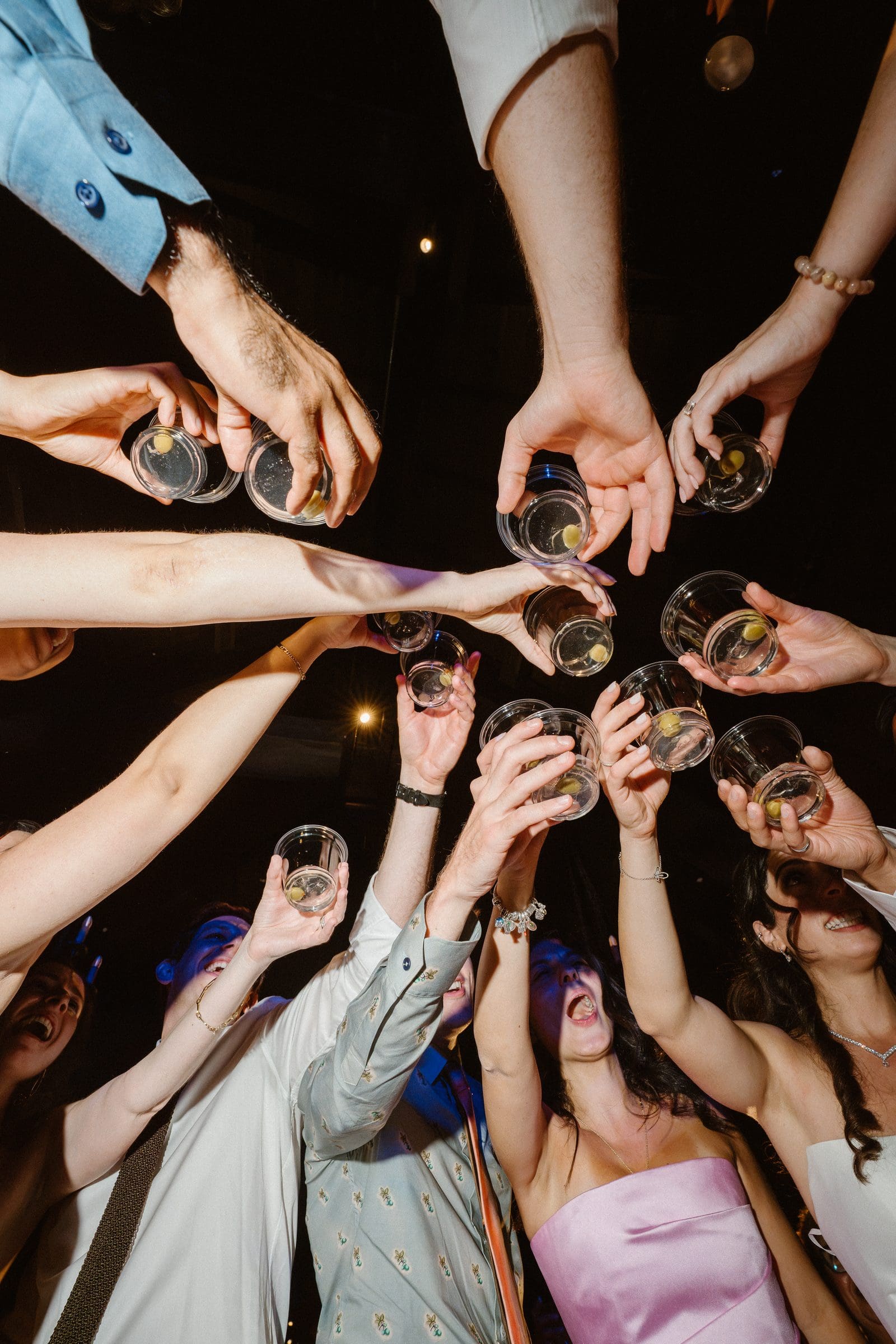 Guests raising their glasses on the dance floor