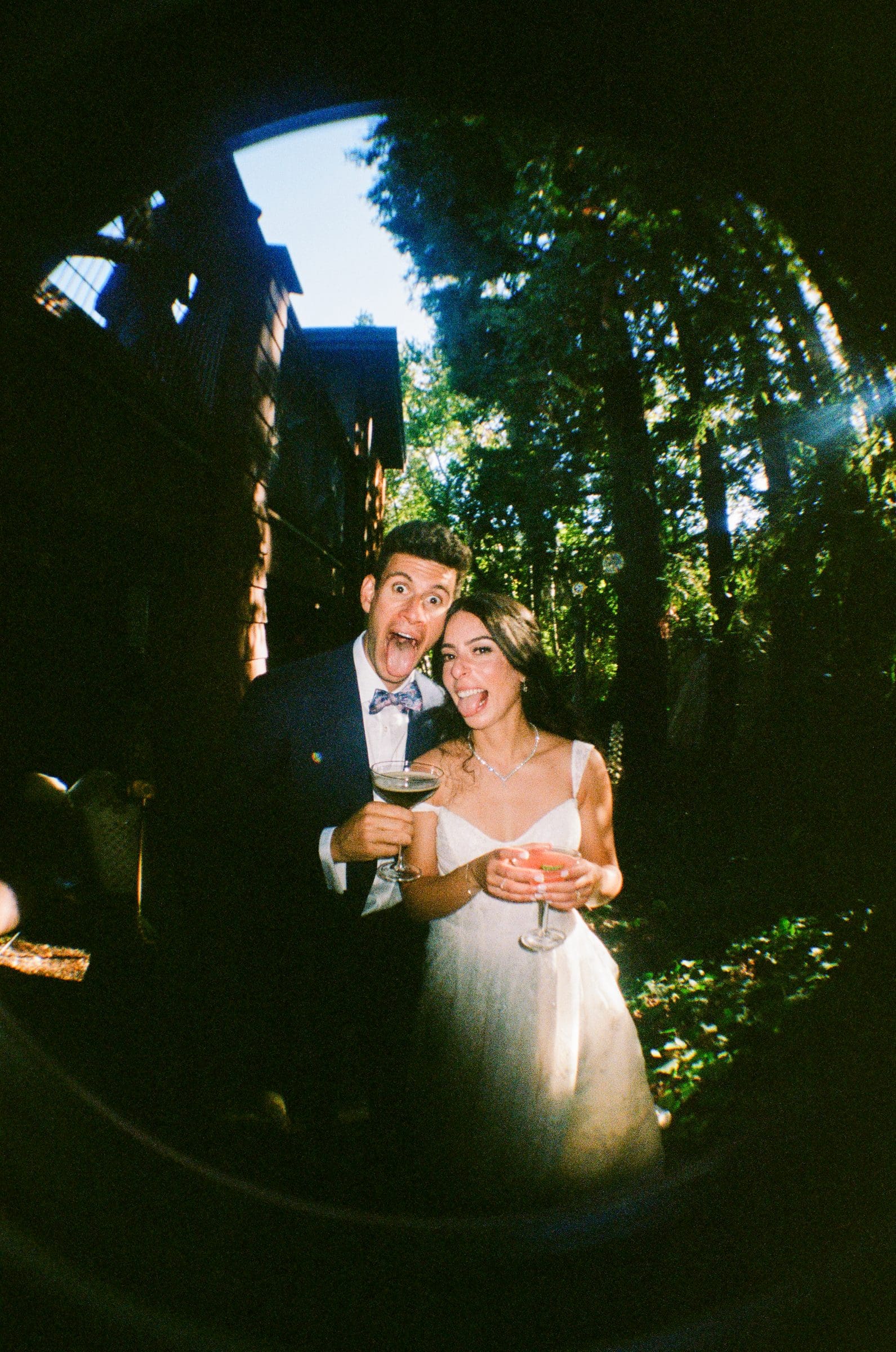 Adam and Lala with drinks at cocktail hour, fisheye on film