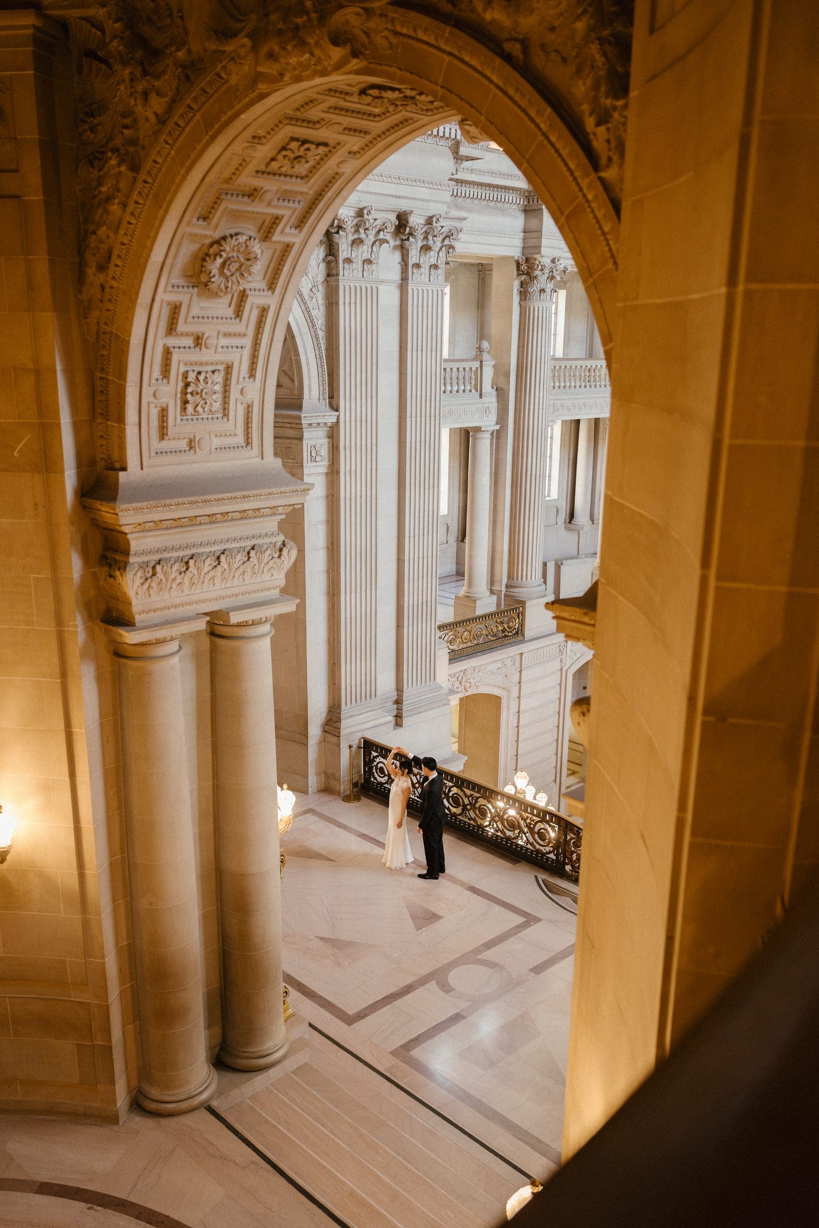 Looking down through a gold archway at City Hall