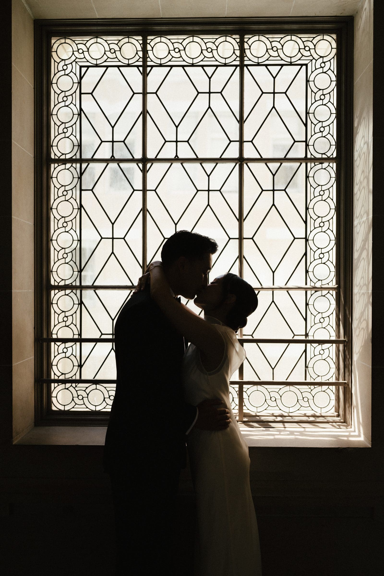 David and Michelle silhouetted against a City Hall window