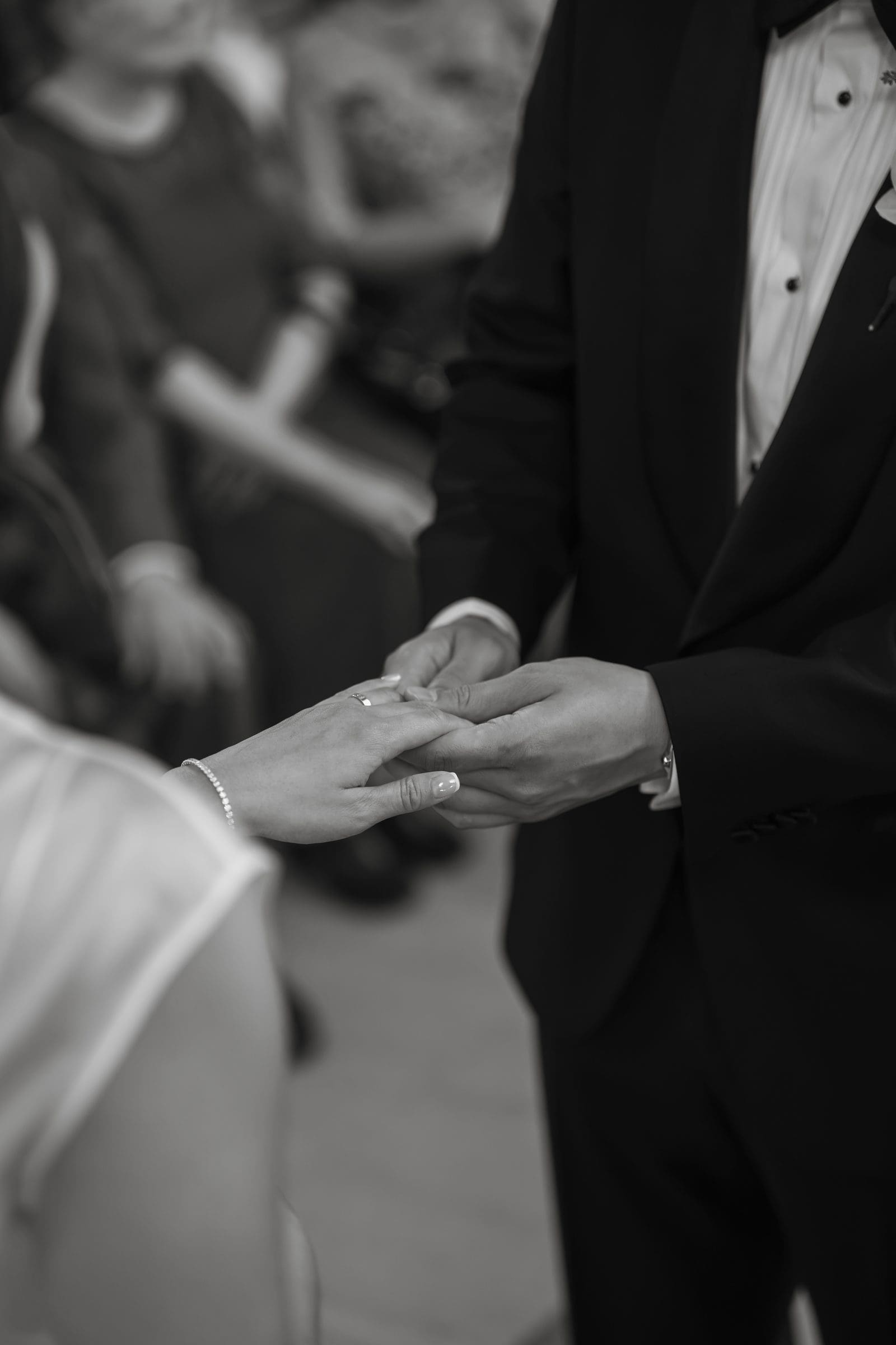 Exchanging rings during the ceremony, black and white