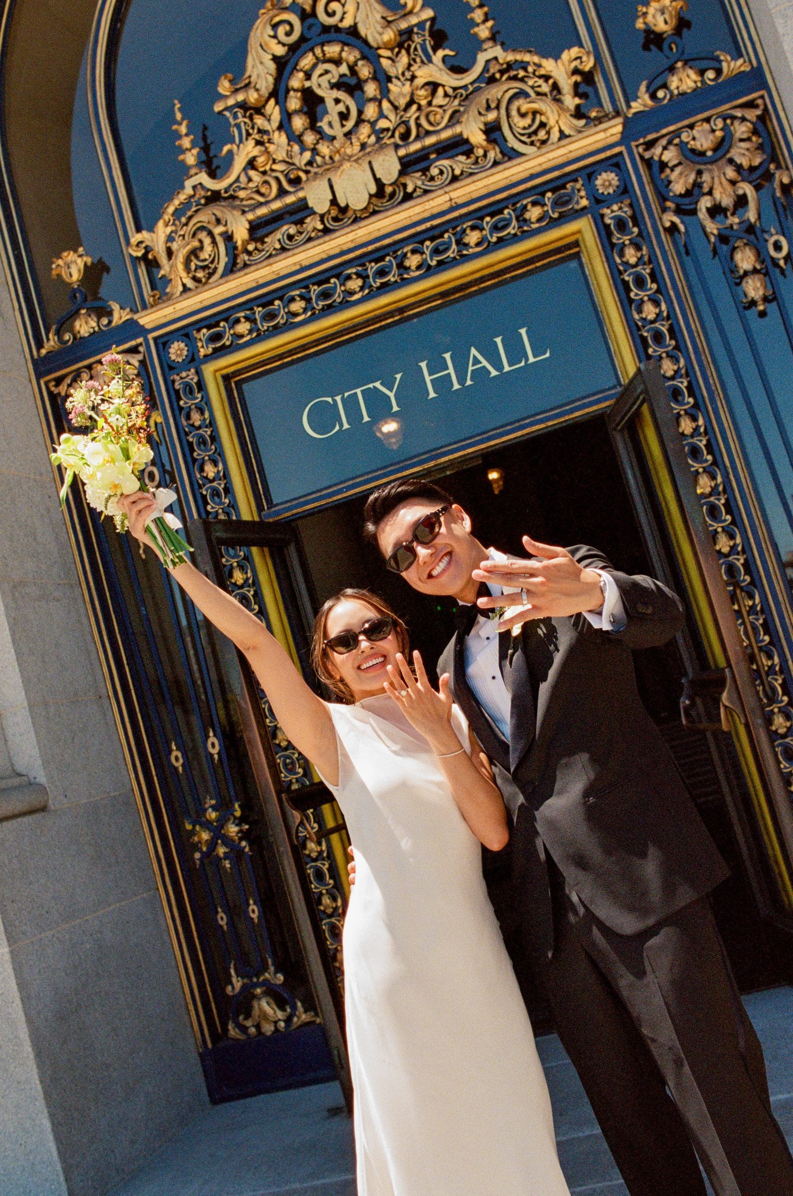 David and Michelle celebrating under the City Hall sign, on film