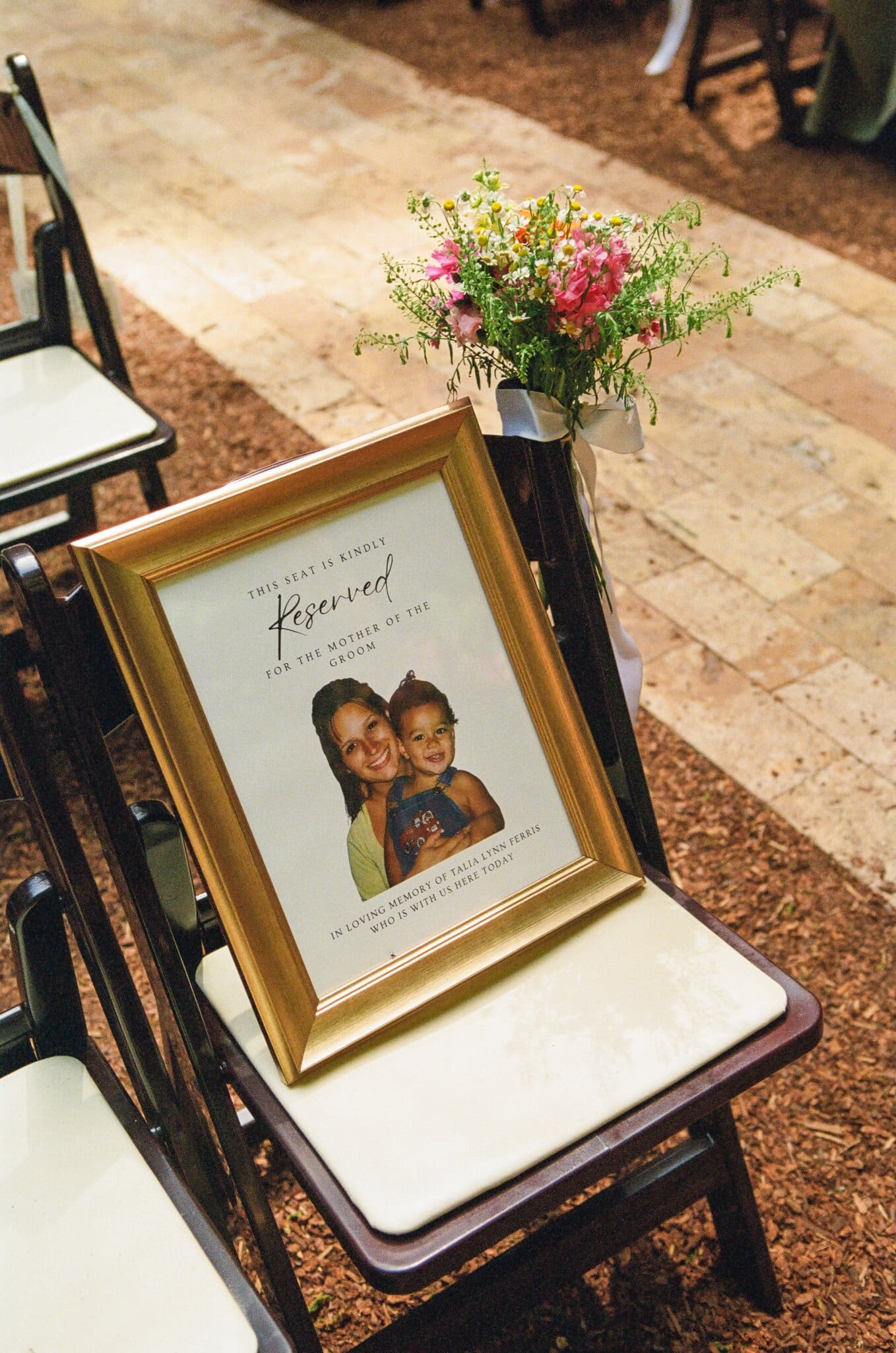 Reserved seat with a framed family photo honoring loved ones at the ceremony