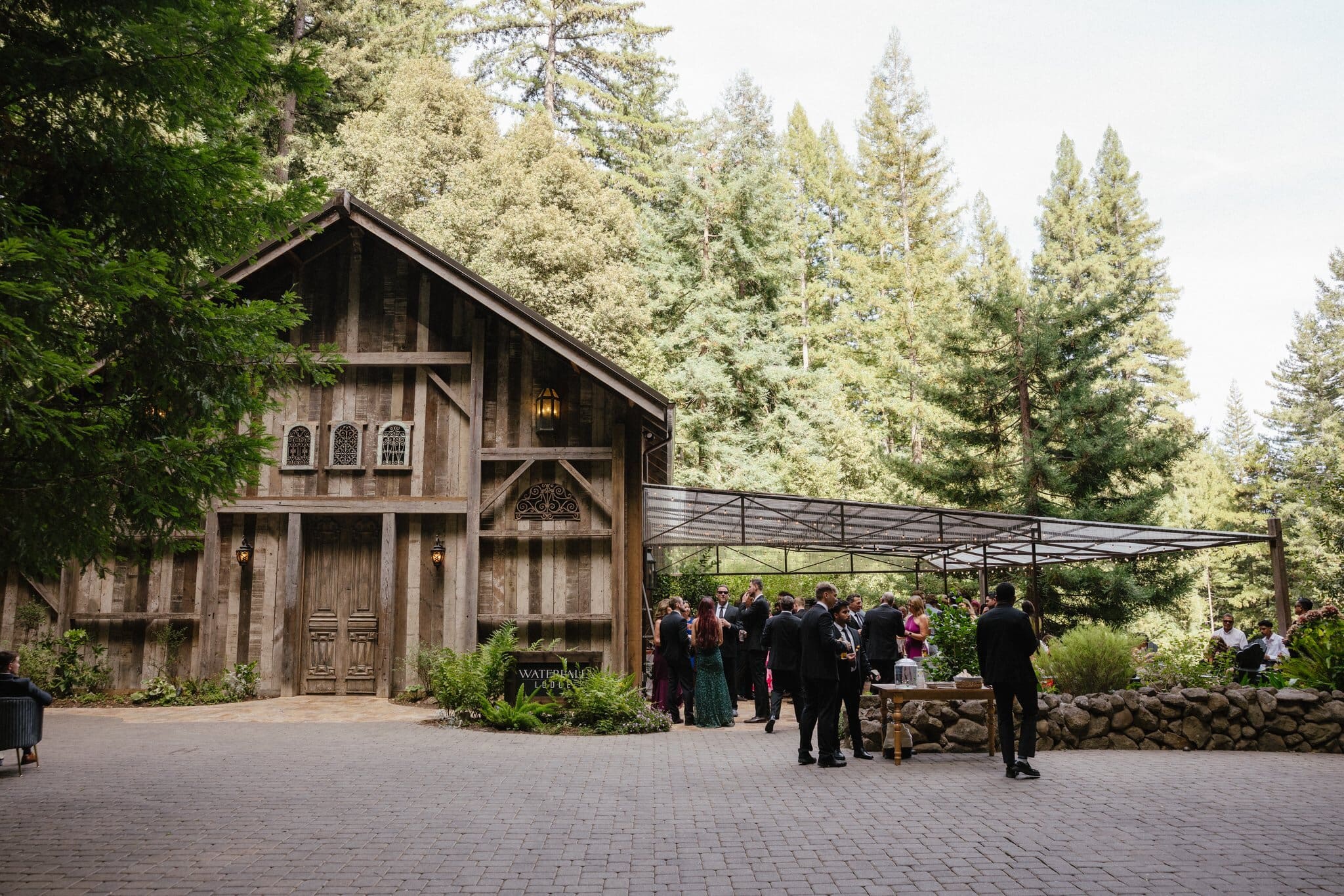 Guests gathered outside the barn at Waterfall Lodge & Retreat during cocktail hour
