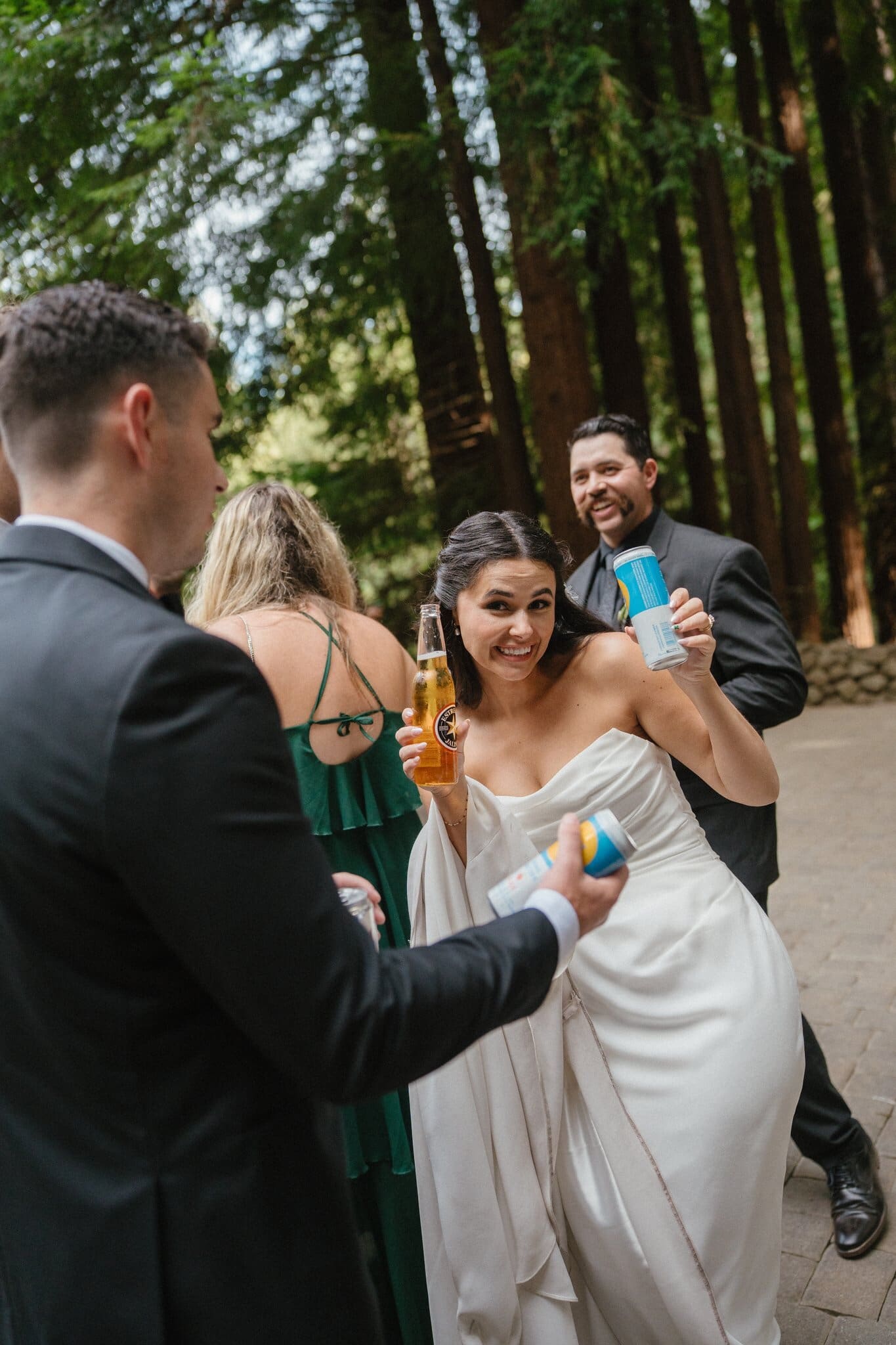 Sofia toasting with friends during cocktail hour in the redwoods