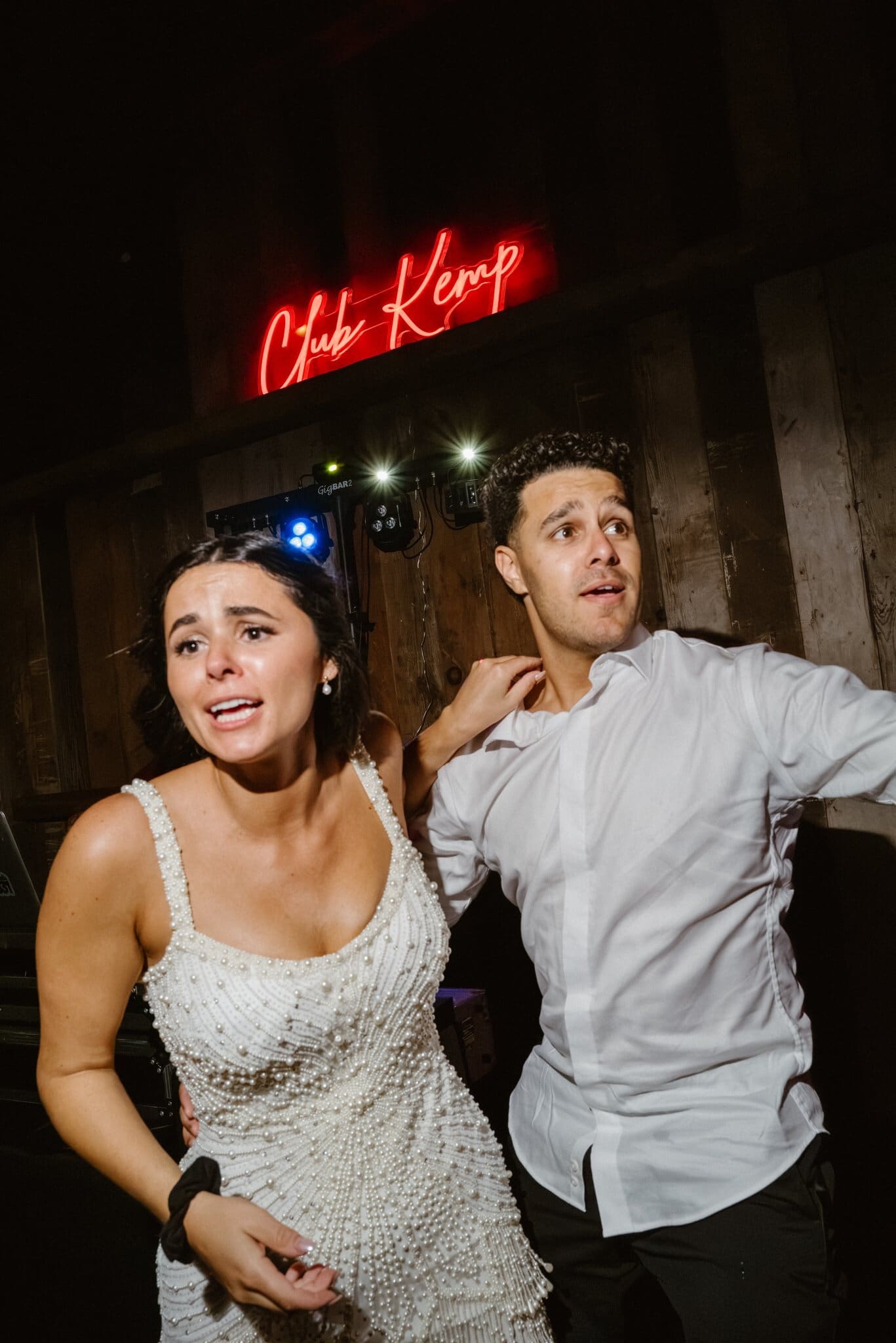 Sofia and Devin dancing under the Club Kemp neon sign
