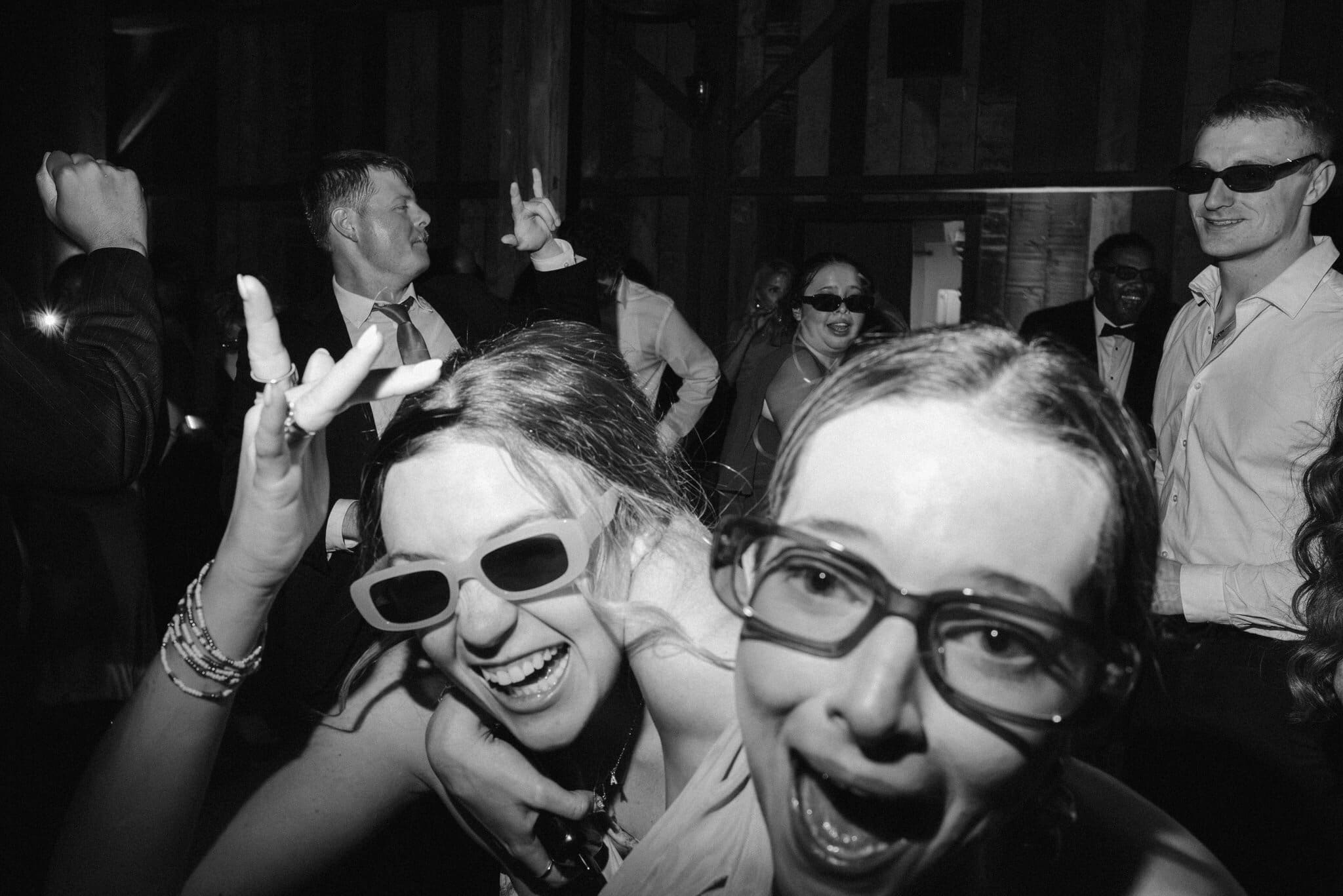Friends in sunglasses on the dance floor, black and white