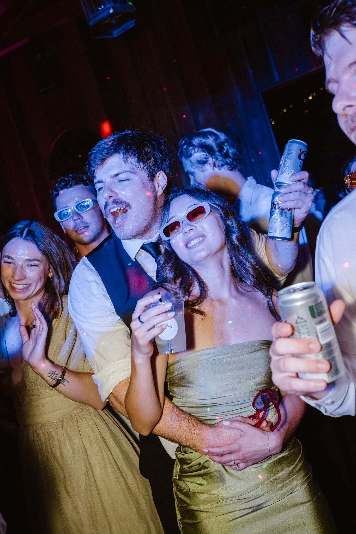Friends dancing together in sunglasses