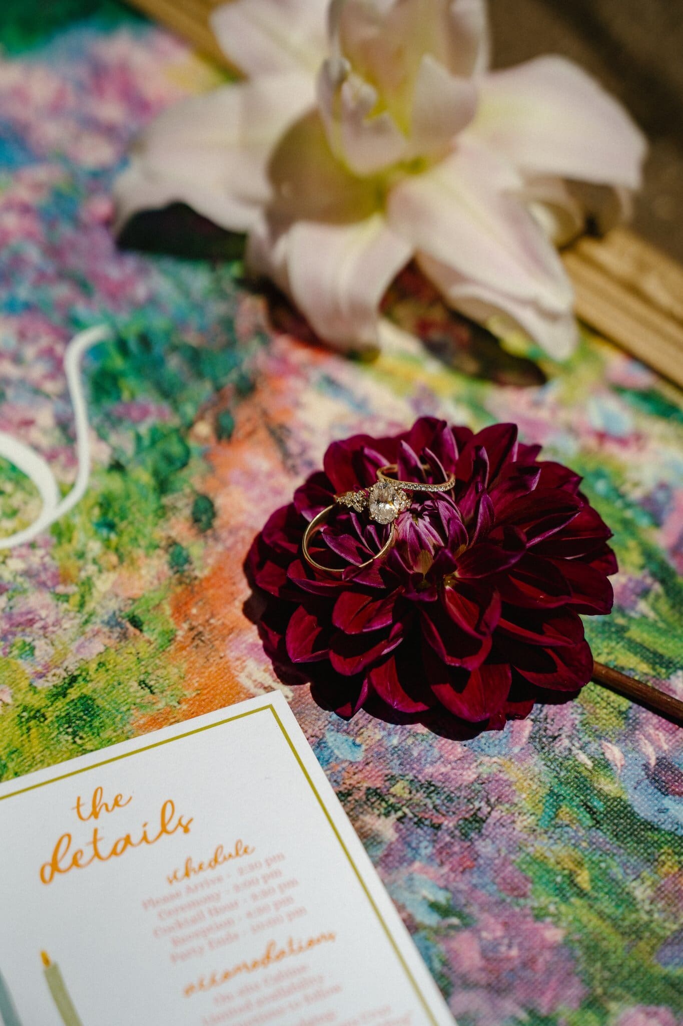 Wedding rings on a dahlia with the hand-painted invitation suite