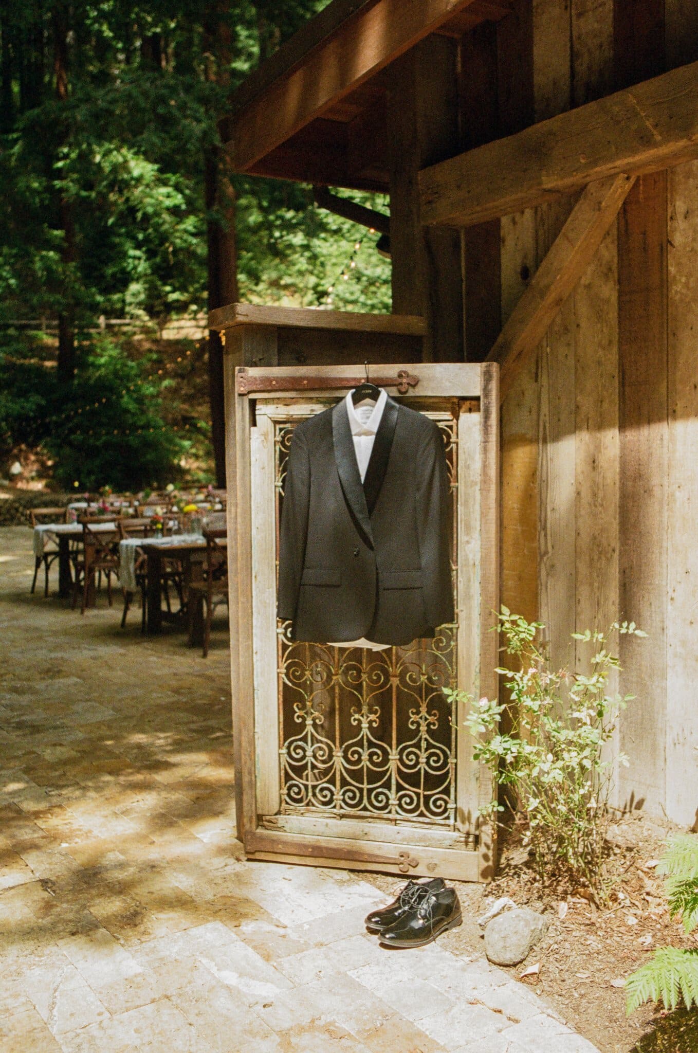 Groom's suit hanging on a vintage door at Waterfall Lodge & Retreat