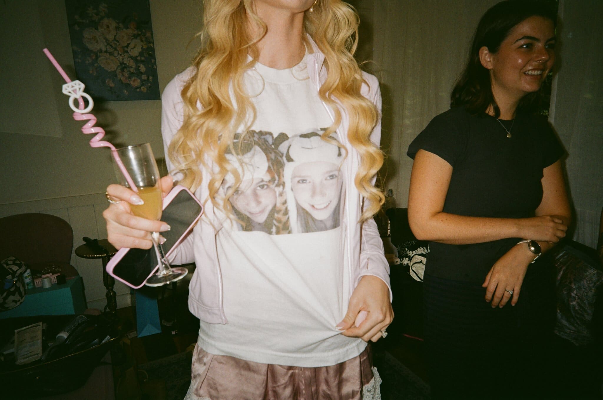 Friend of the bride showing off a custom shirt while getting ready, on film