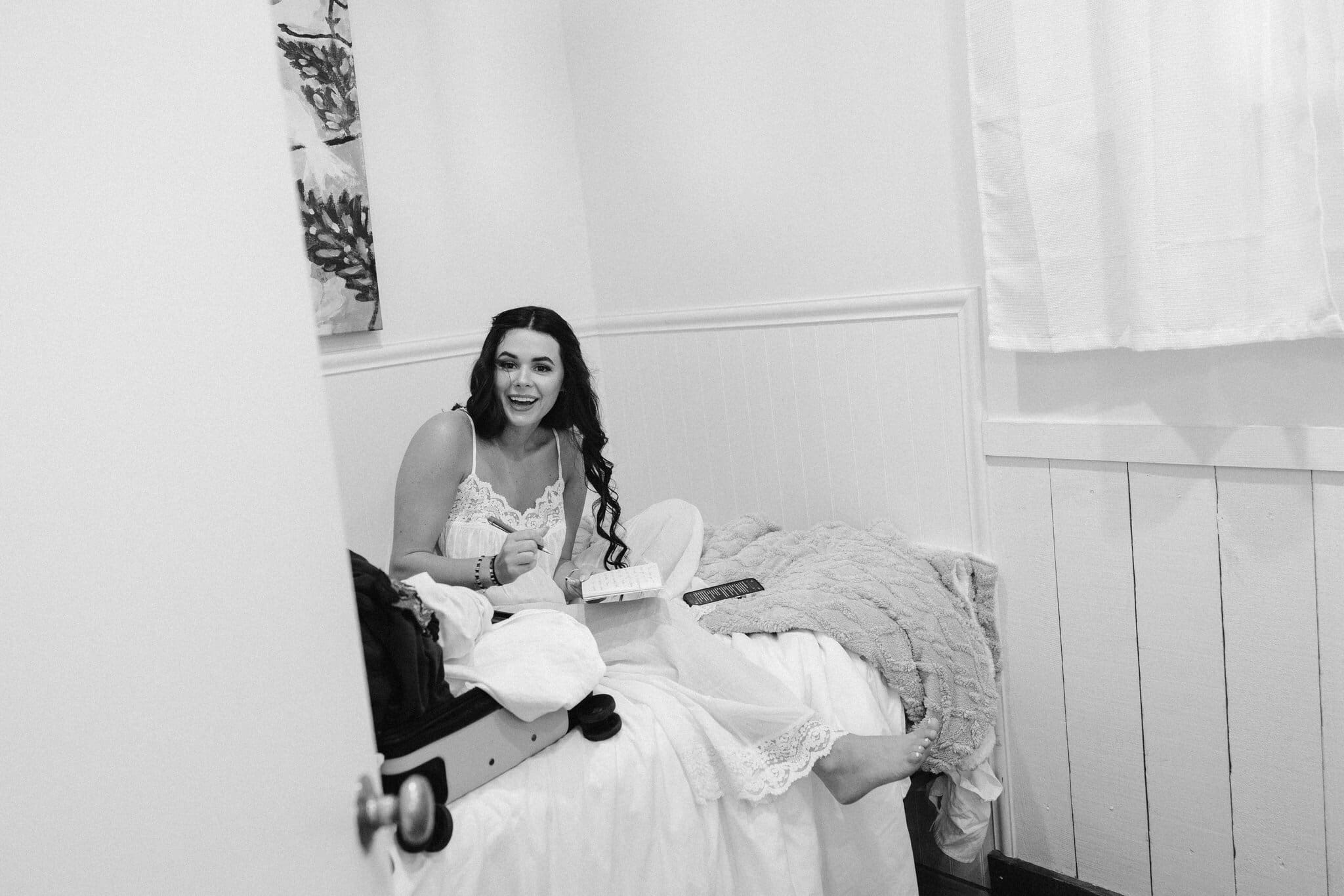 Sofia laughing with friends while getting ready, black and white