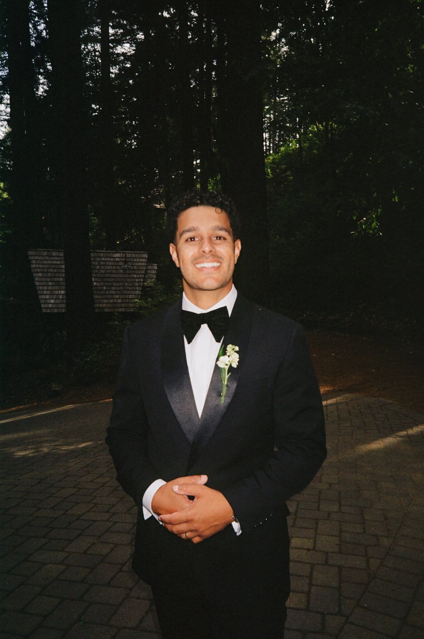 Portrait of Devin in his tuxedo among the redwoods, on film