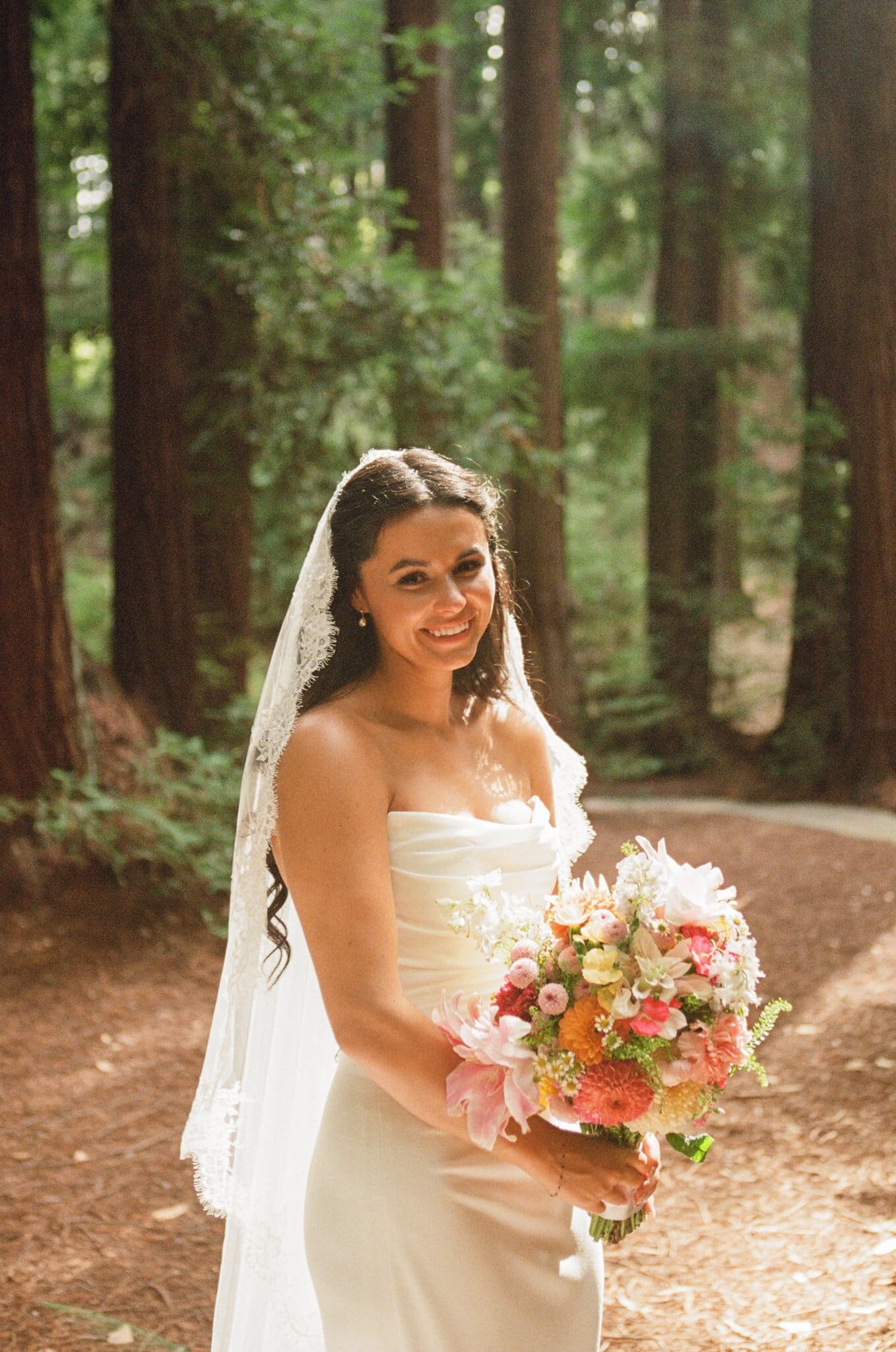 Portrait of Sofia with her bouquet in the redwoods, on film