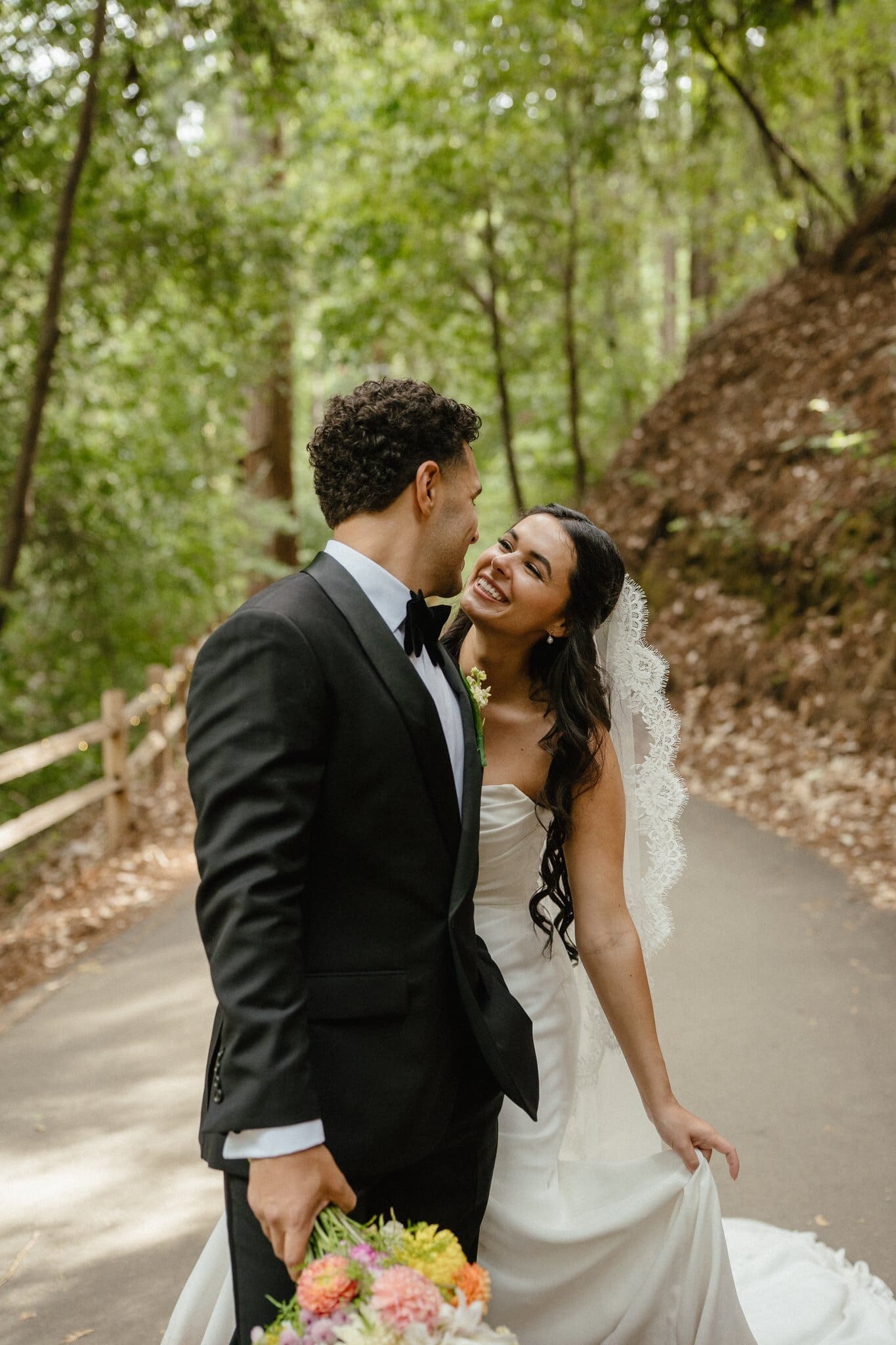 Sofia laughing with Devin on a redwood path