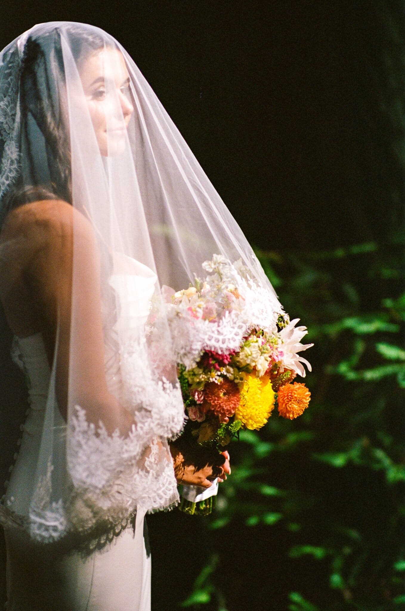 Sofia under her veil with her bouquet, on film