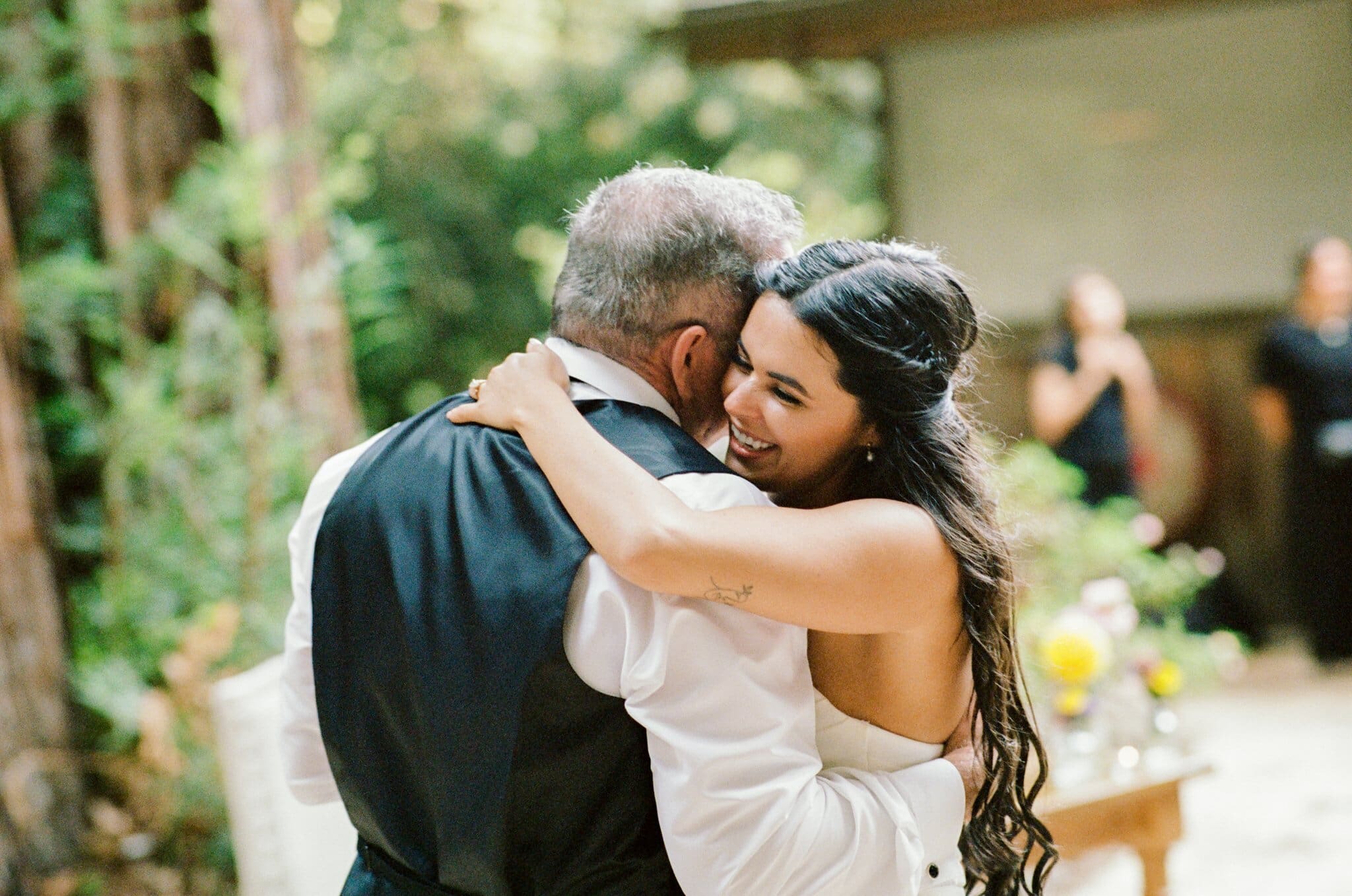 Sofia sharing a hug with a loved one at the reception, on film