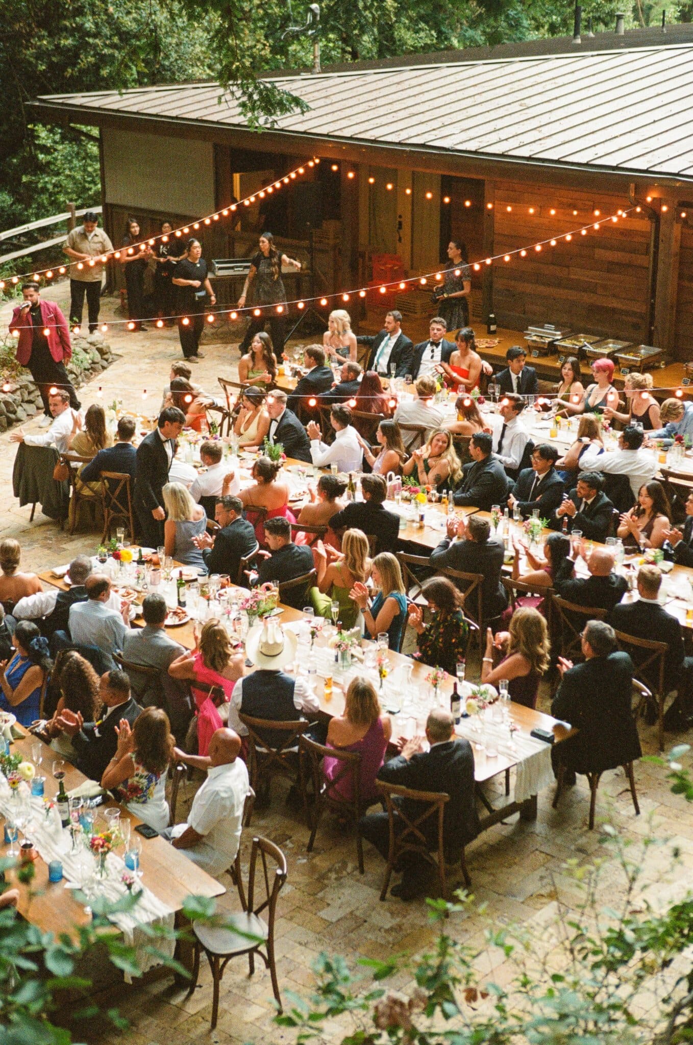 Guests at long tables during dinner at Waterfall Lodge & Retreat, on film