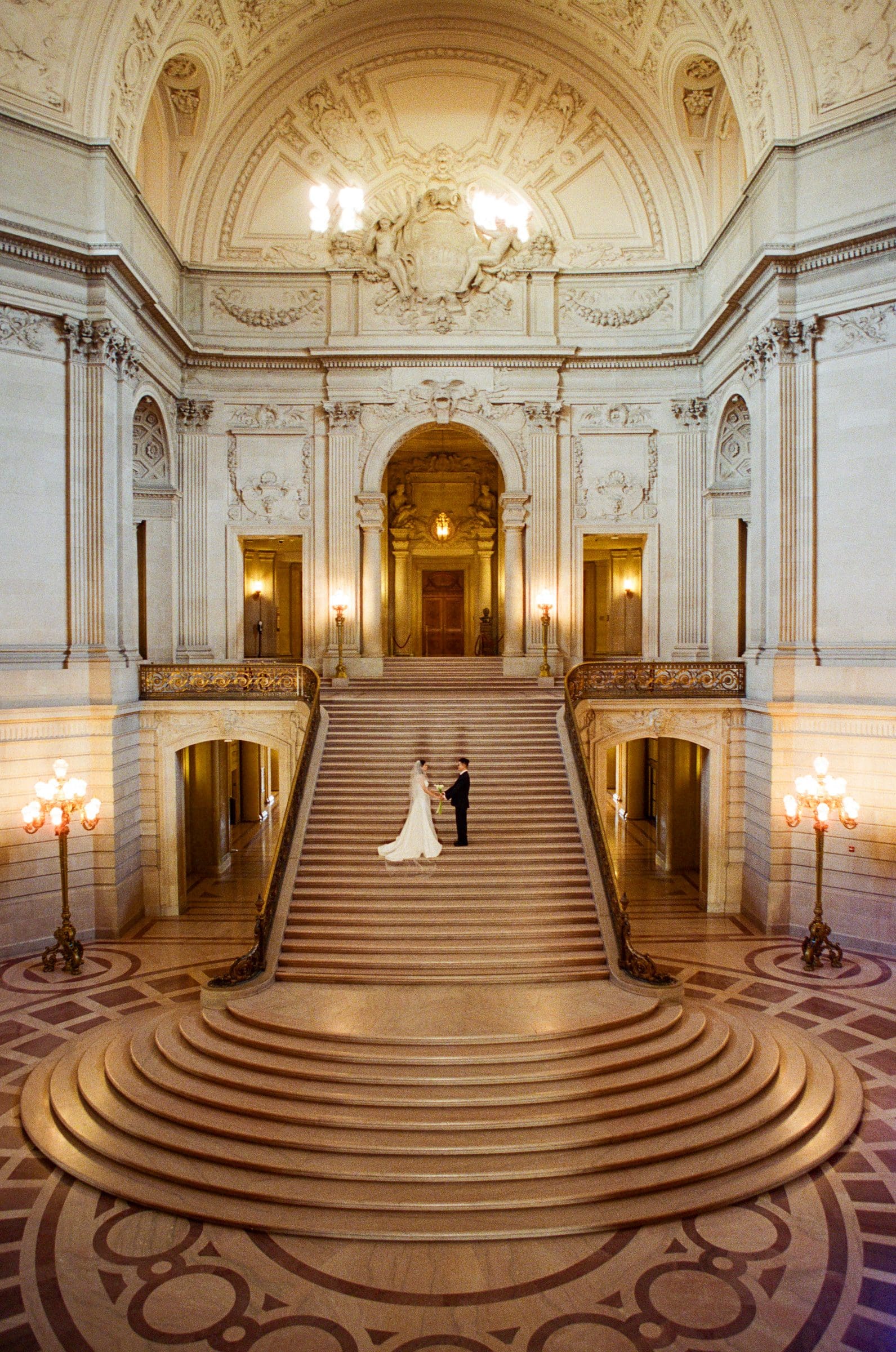Hsiang and Ting at the top of the grand staircase at San Francisco City Hall, on film