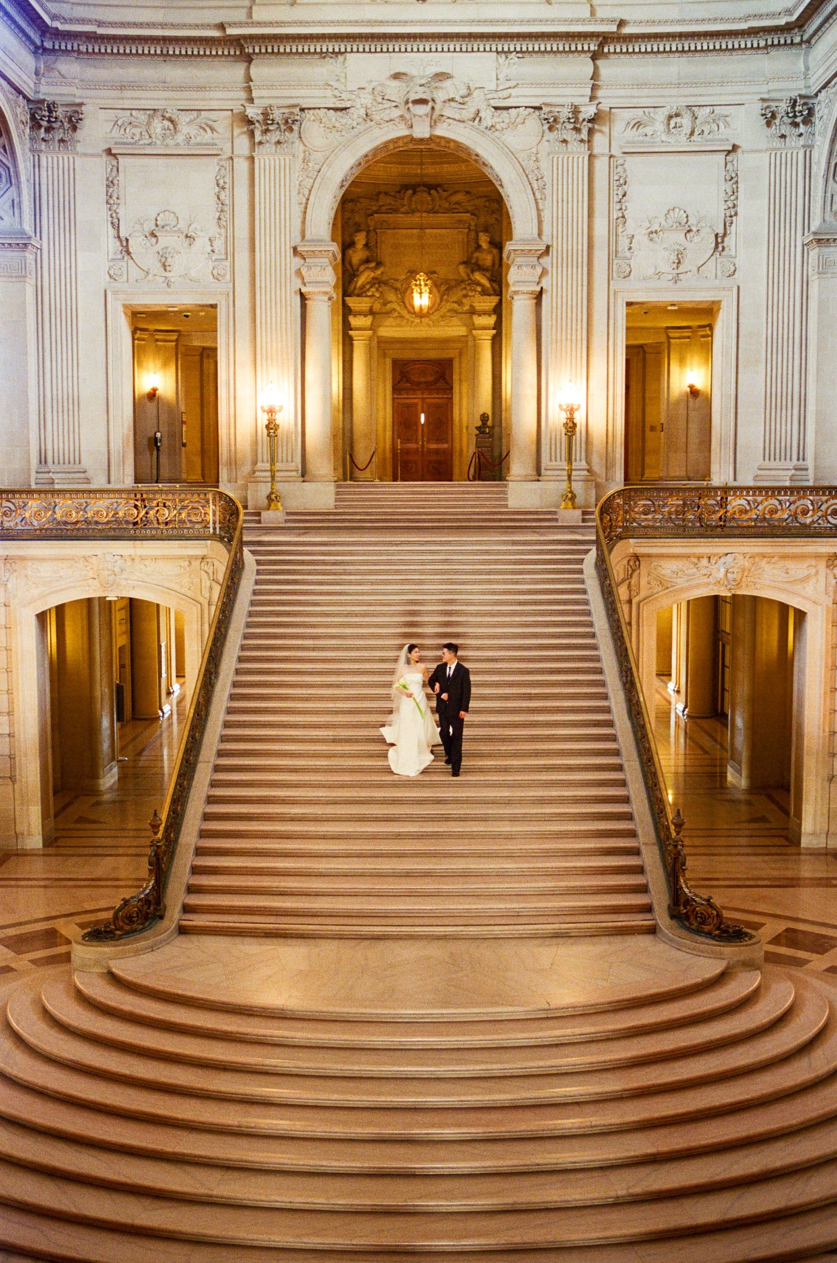 Wide view of Hsiang and Ting on the City Hall staircase, on film