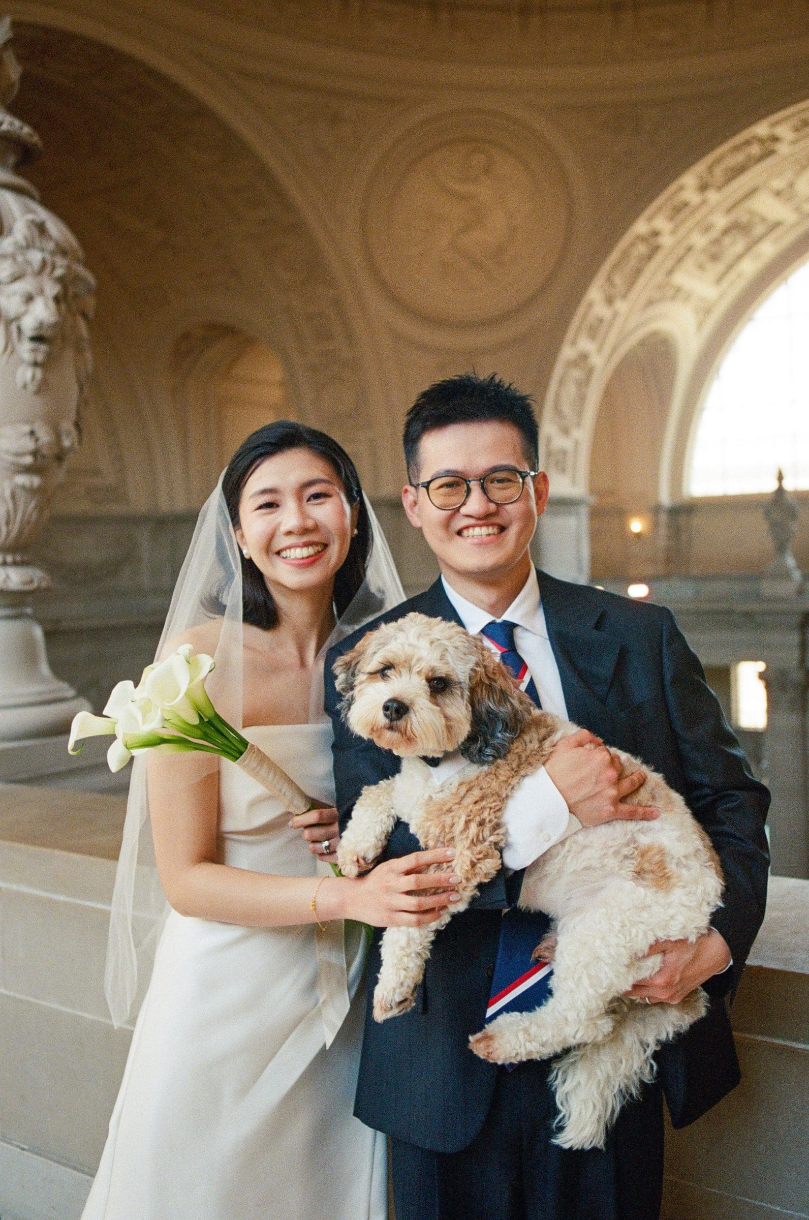 Hsiang and Ting holding their dog at City Hall, on film