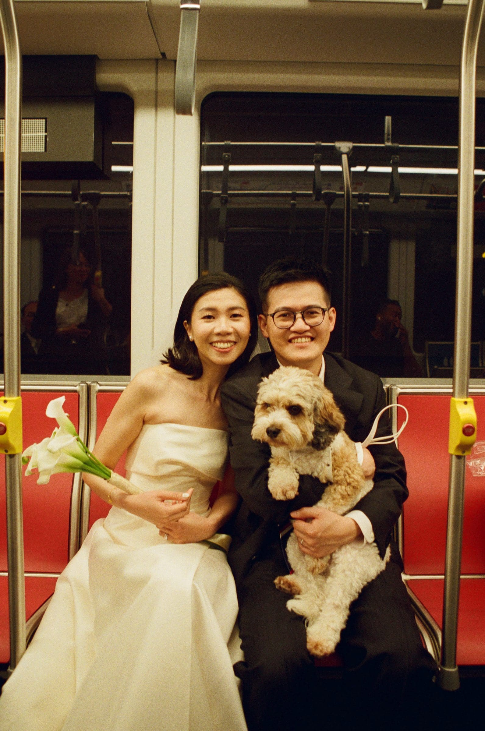 Hsiang and Ting riding Muni with their dog, on film