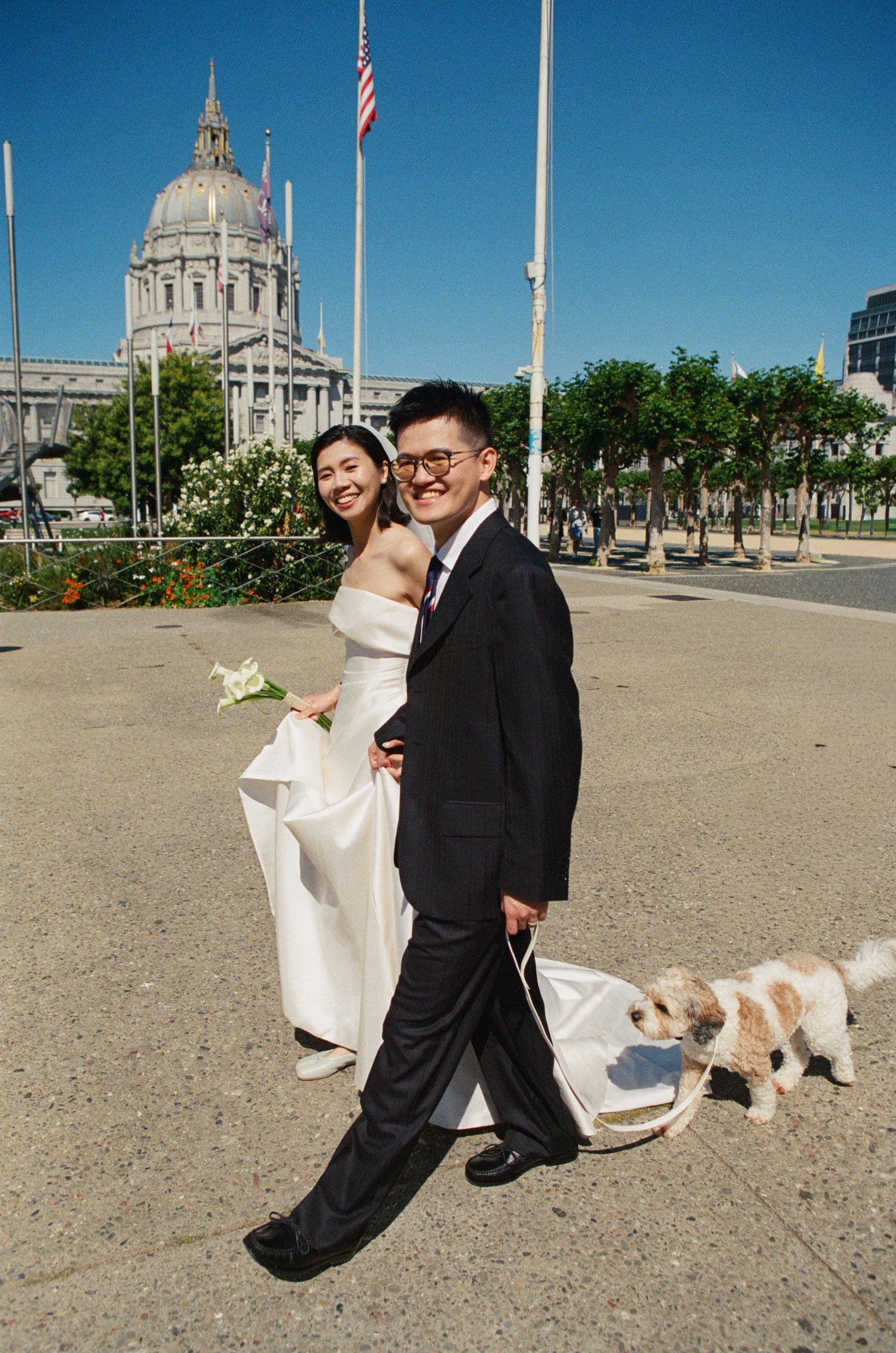 Hsiang and Ting walking with their dog in front of San Francisco City Hall, on film