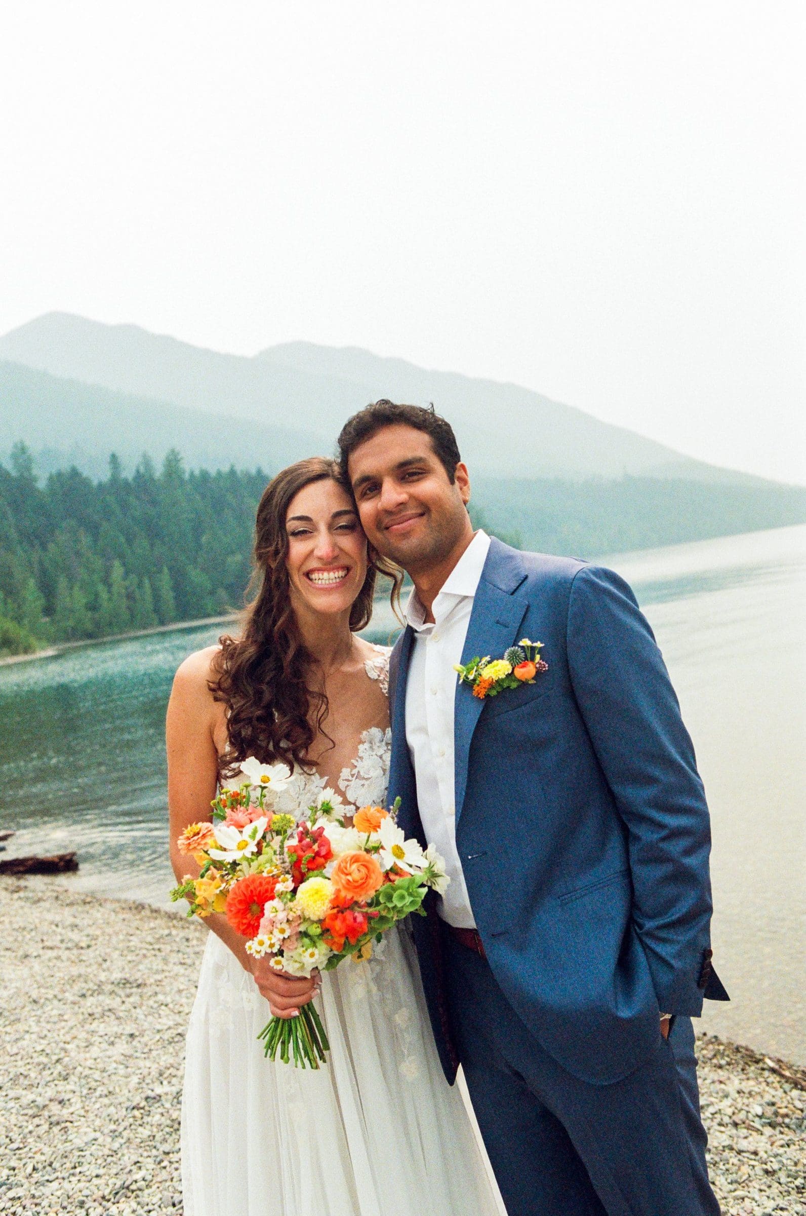 Raj and Isabelle with her bouquet on the shore of Lake McDonald, Montana, on film