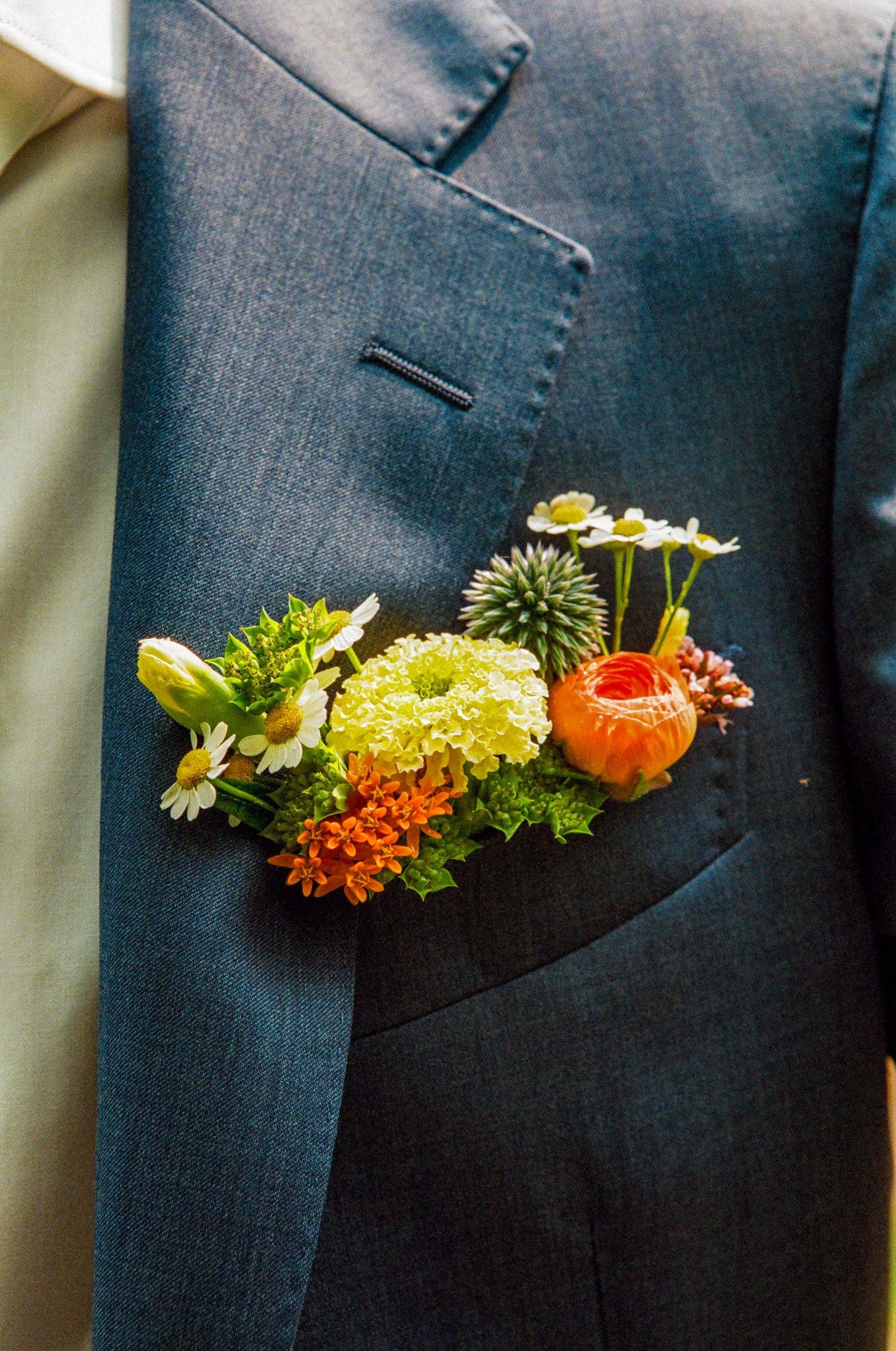 Raj's orange and yellow boutonniere on his blue suit, on film