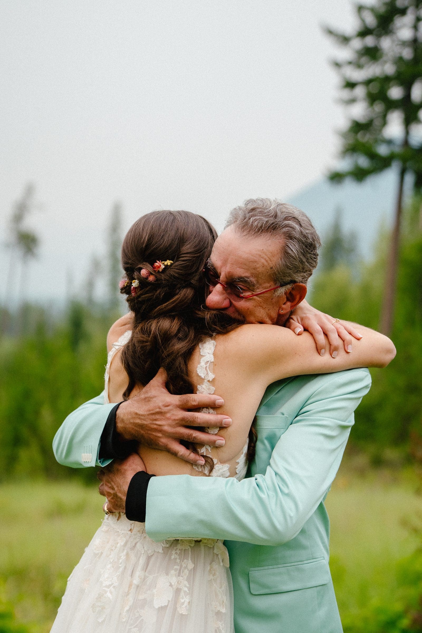 Isabelle hugging her dad in his mint suit