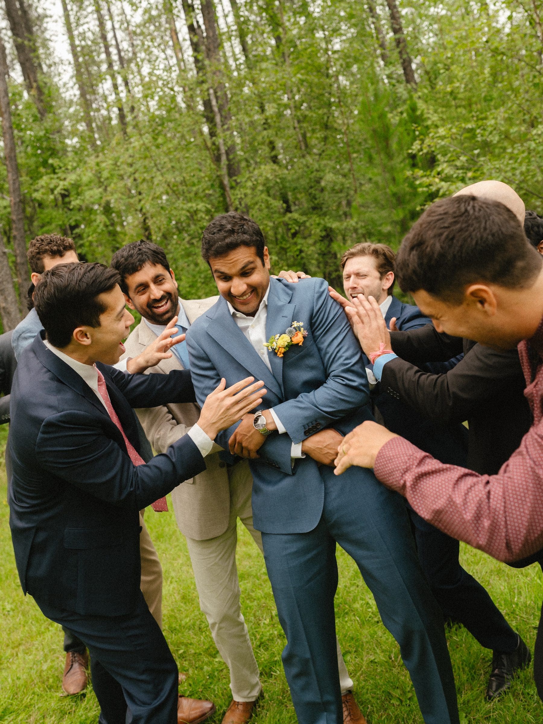 Raj celebrating with his groomsmen on the lawn