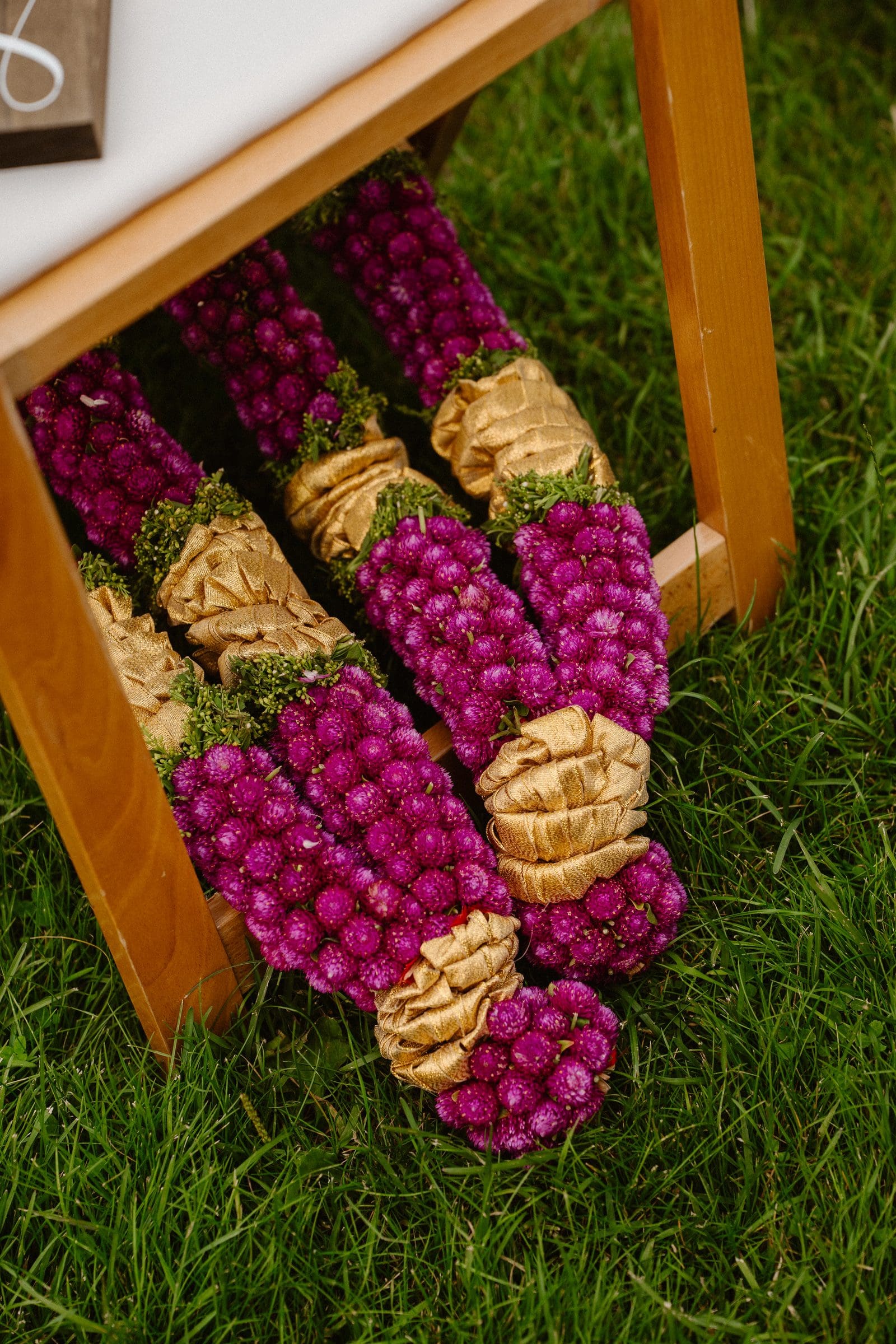 Flower garlands waiting on the grass before the ceremony