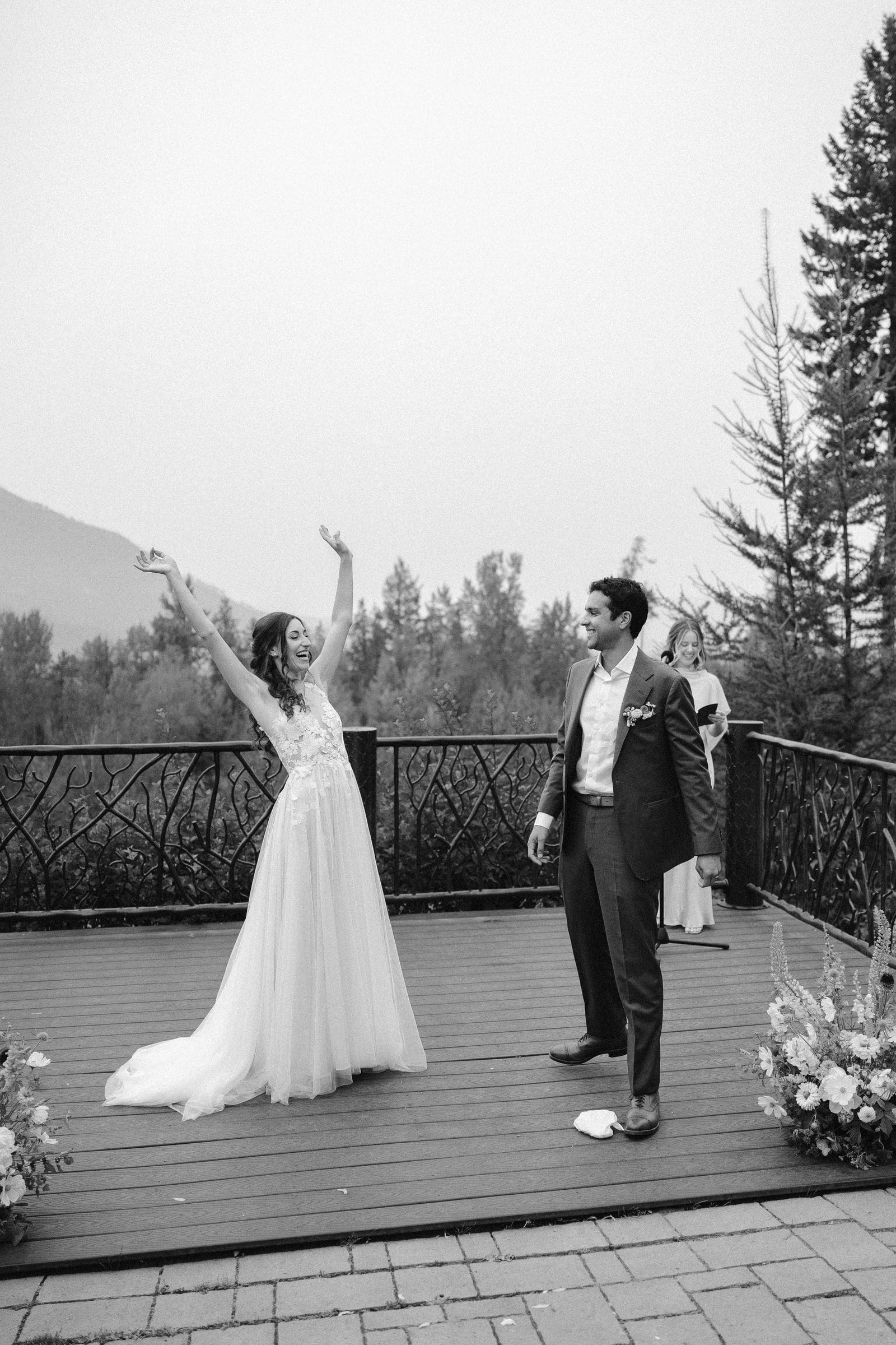 Raj and Isabelle cheering at the end of the ceremony, black and white