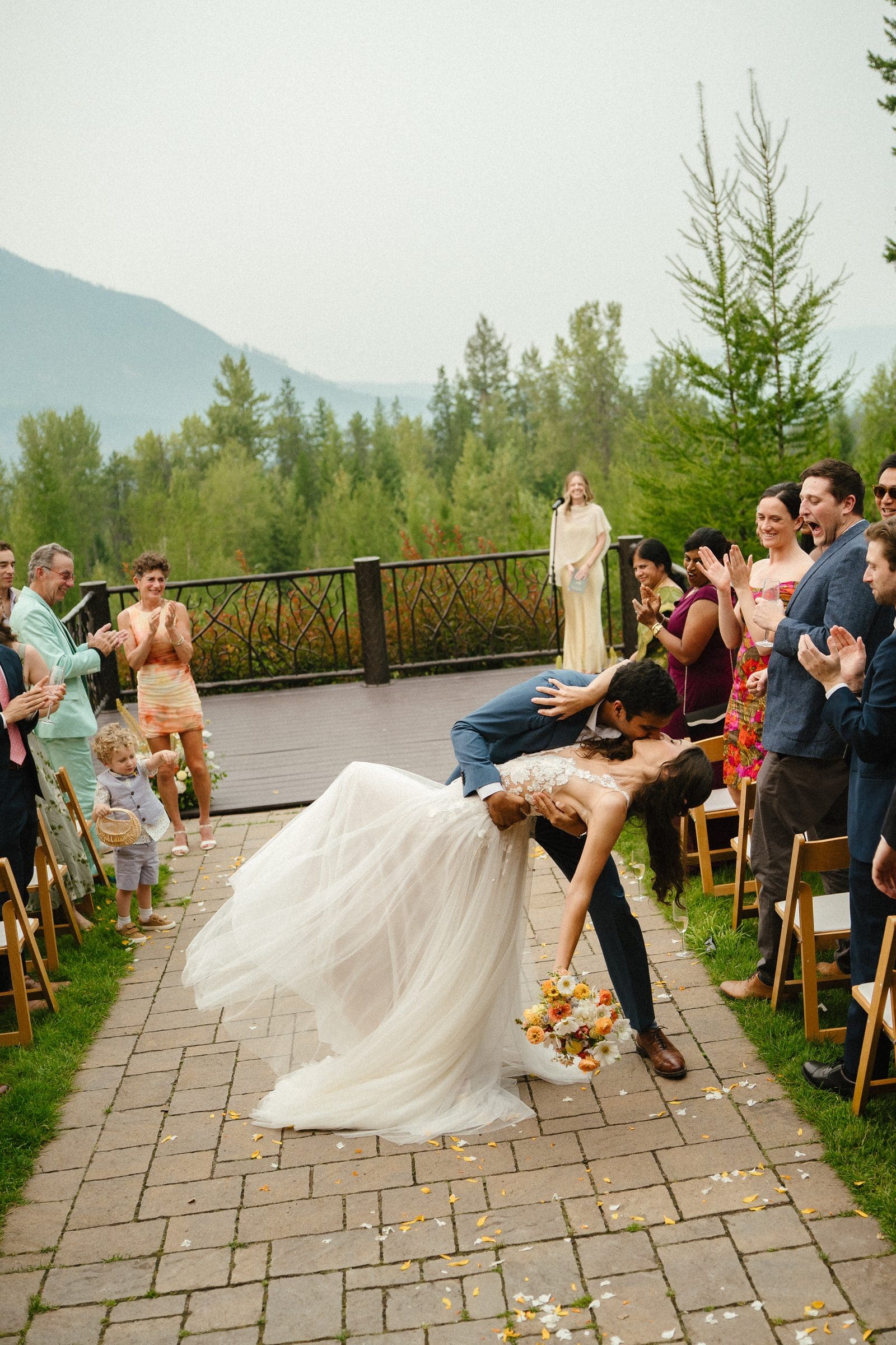 Raj dipping Isabelle in the aisle as guests cheer