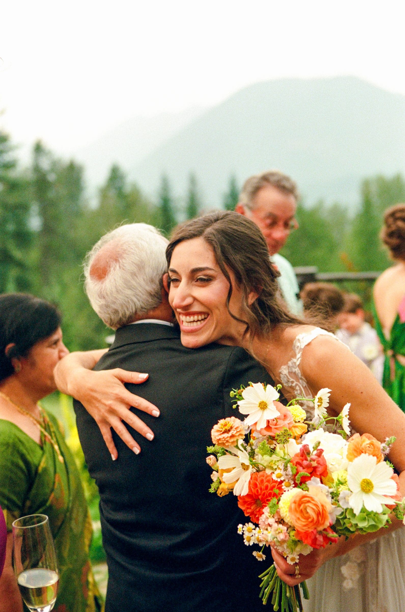 Isabelle hugging family after the ceremony, on film