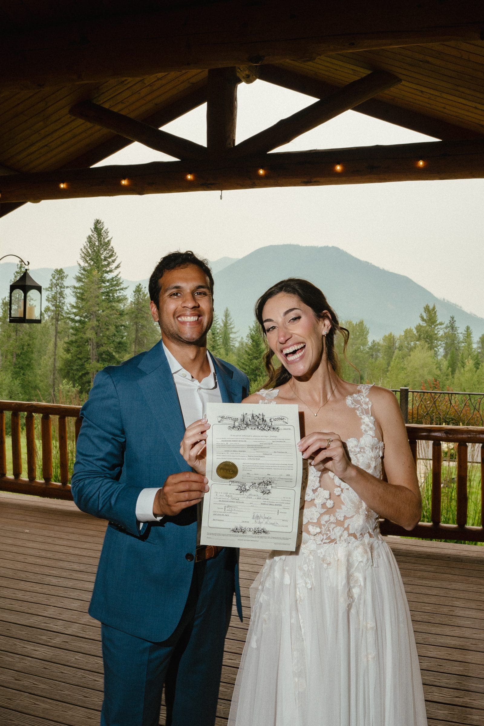 Raj and Isabelle holding up their marriage certificate