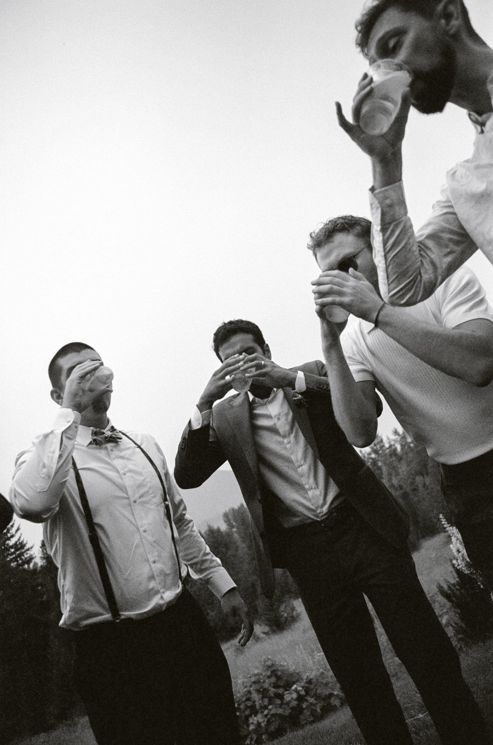Groomsmen sharing a drink, black and white film