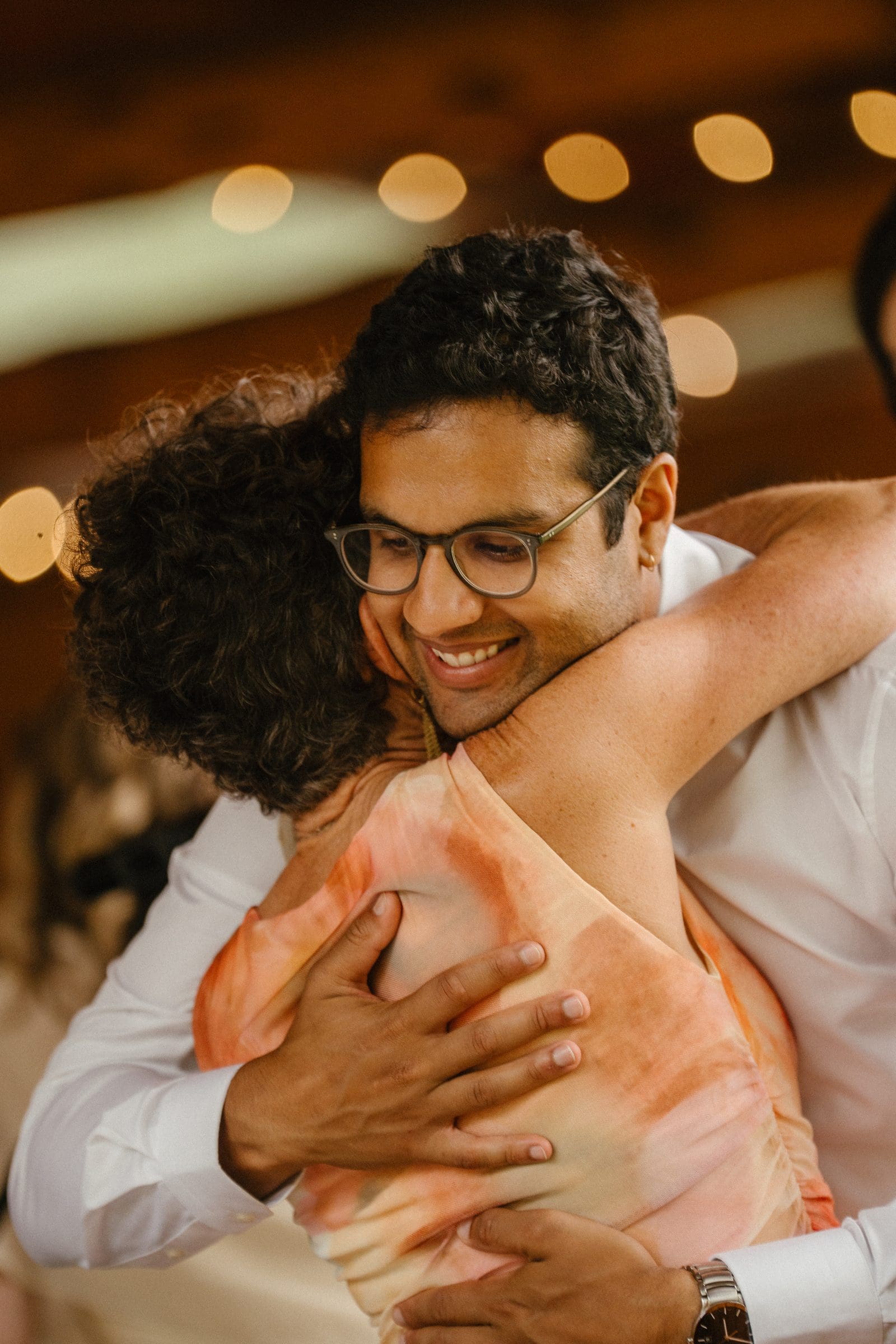 Raj hugging a guest at the reception