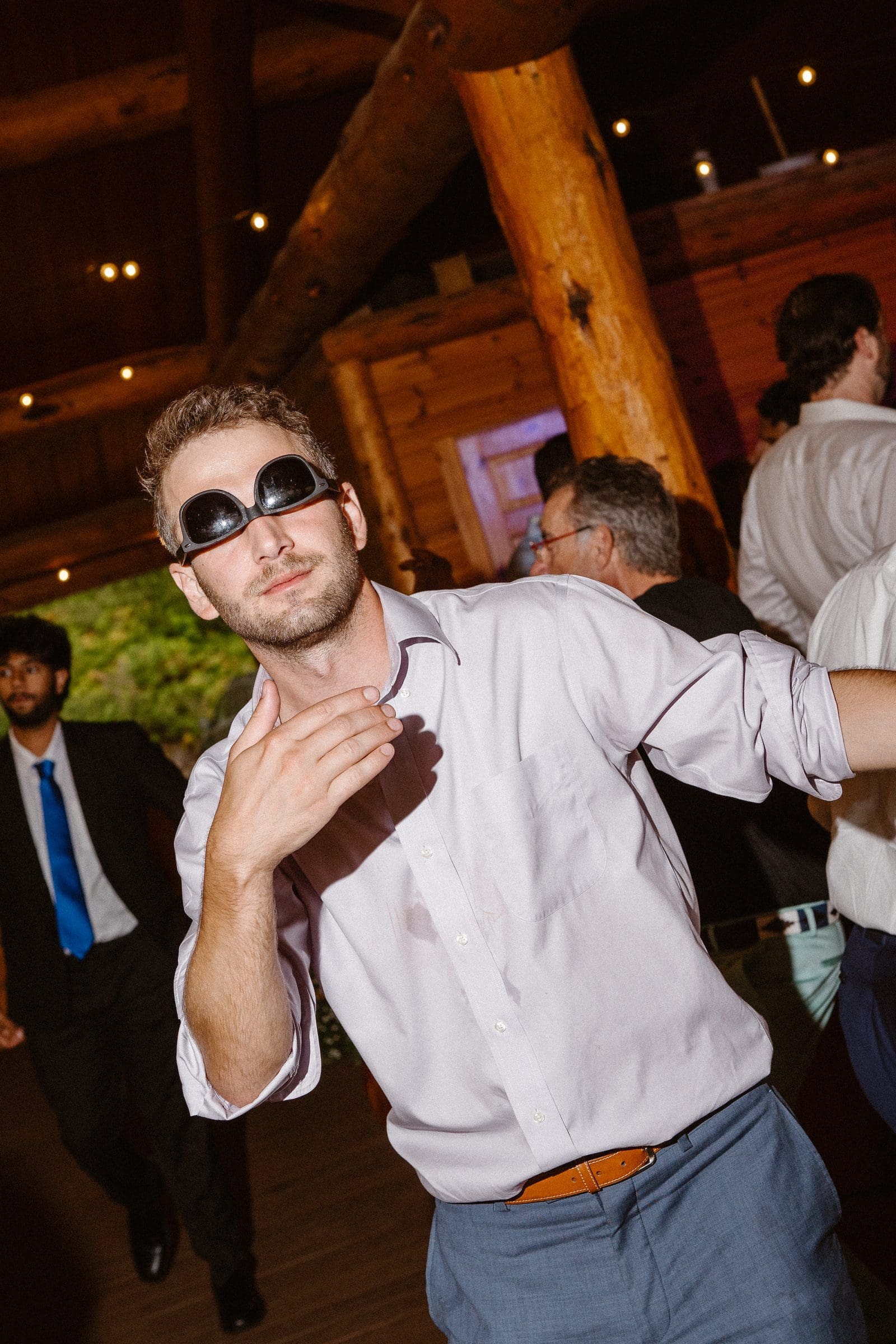 A guest in sunglasses dancing at the reception