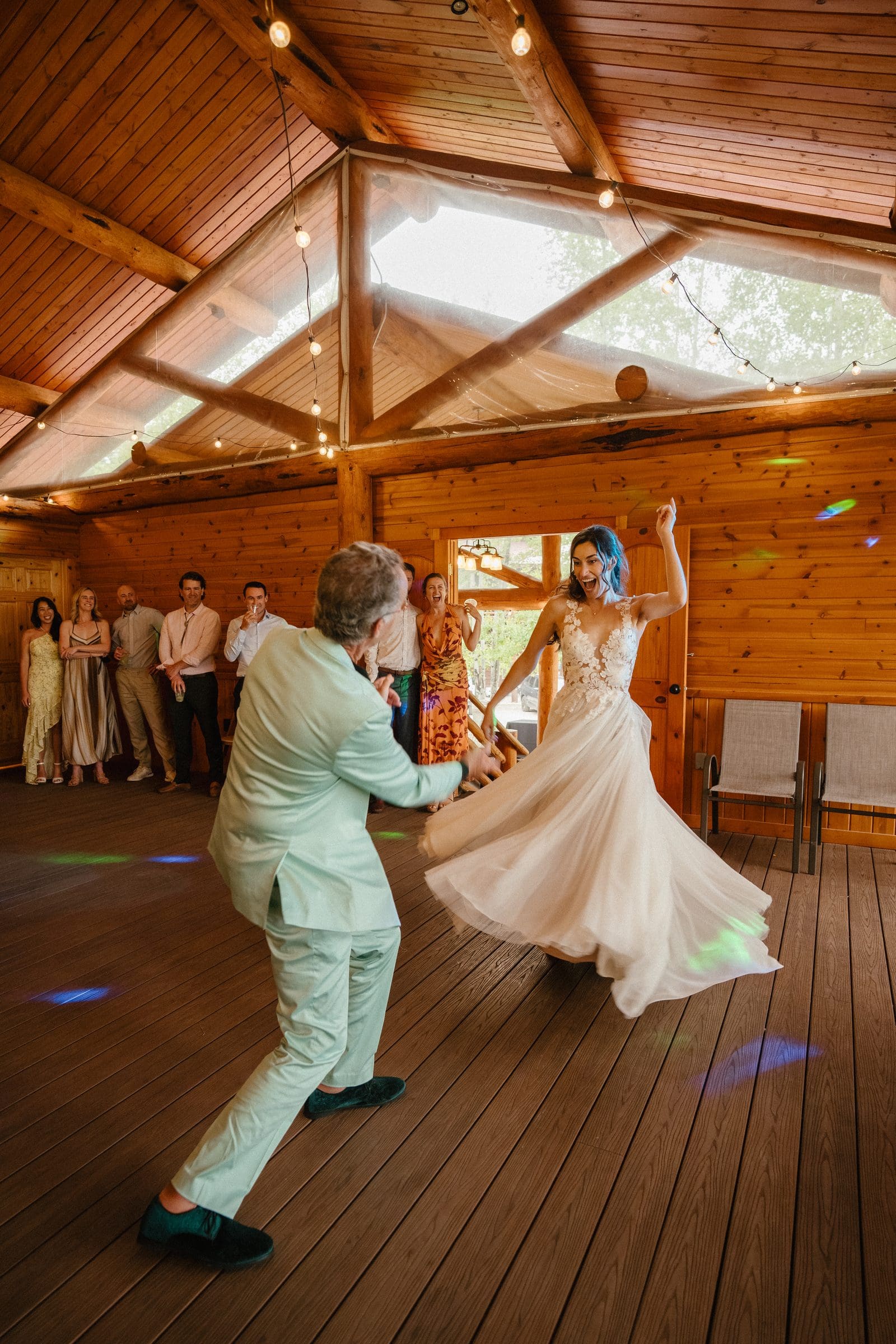 Isabelle twirling on the dance floor with her dad