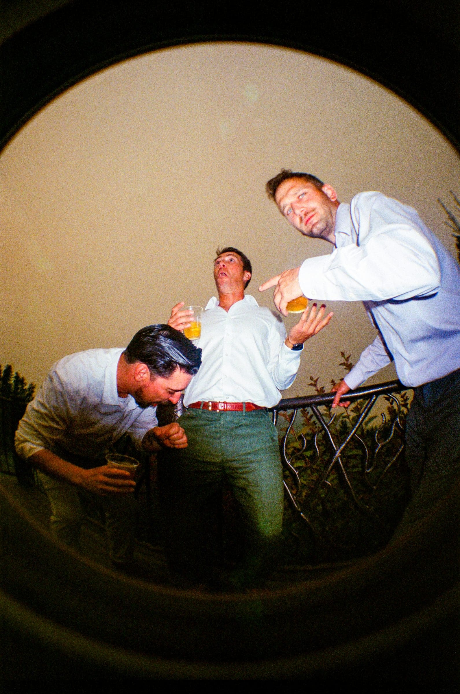 Friends dancing in flash, fisheye on film