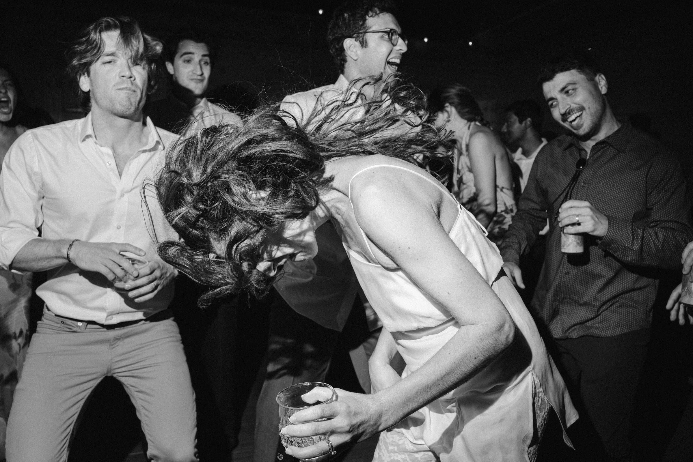 Friends dancing at the reception, black and white